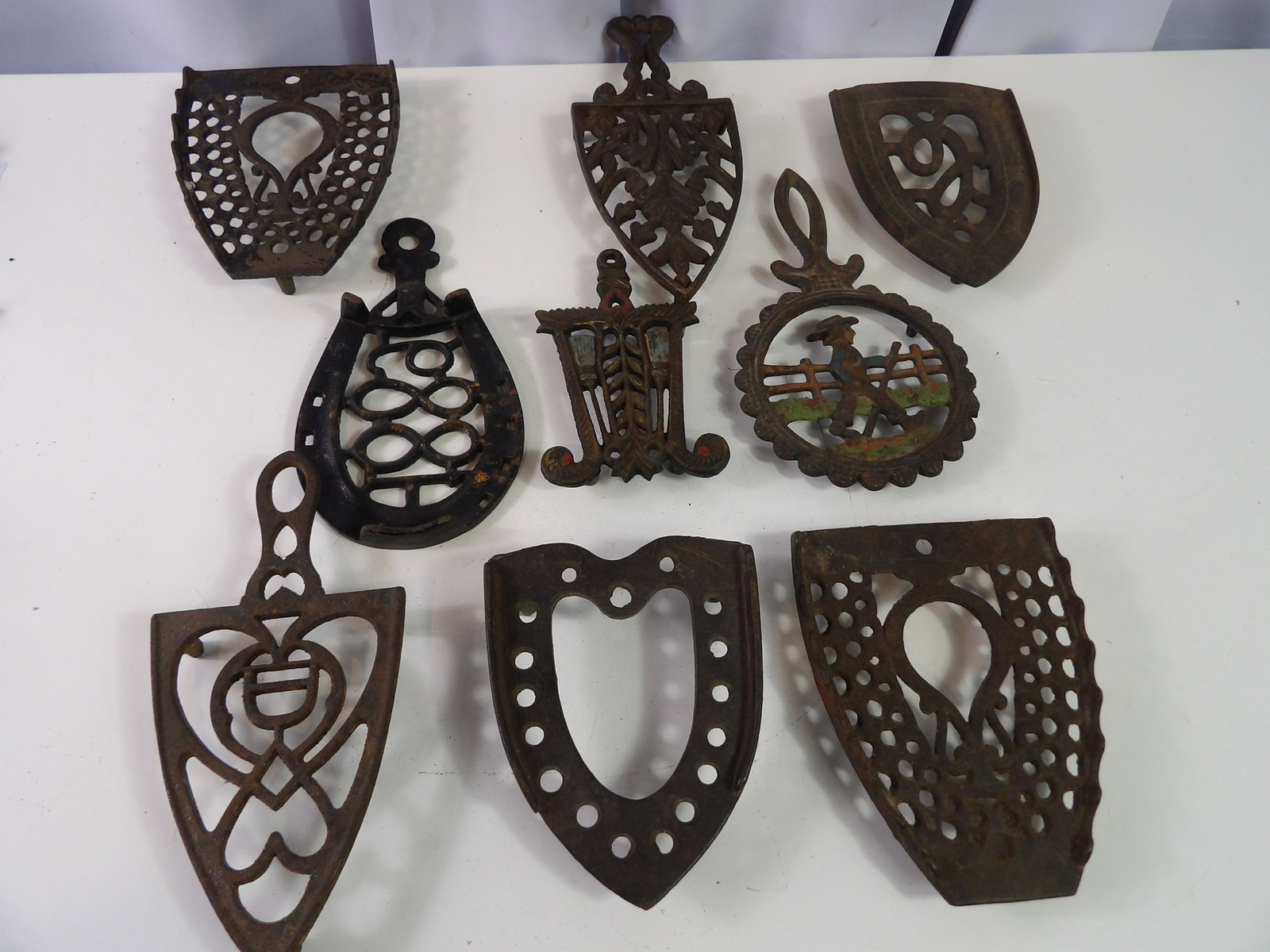 Collection of 9 Cast Iron Trivets (1 of 4)