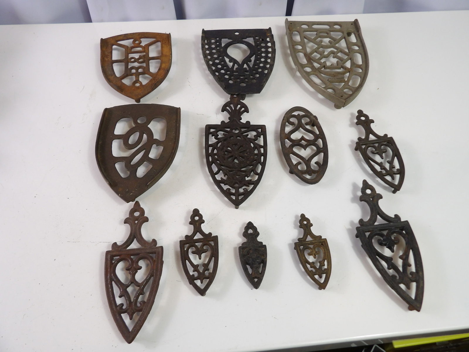 Collection of 12 Cast Iron Trivets (1 of 4)