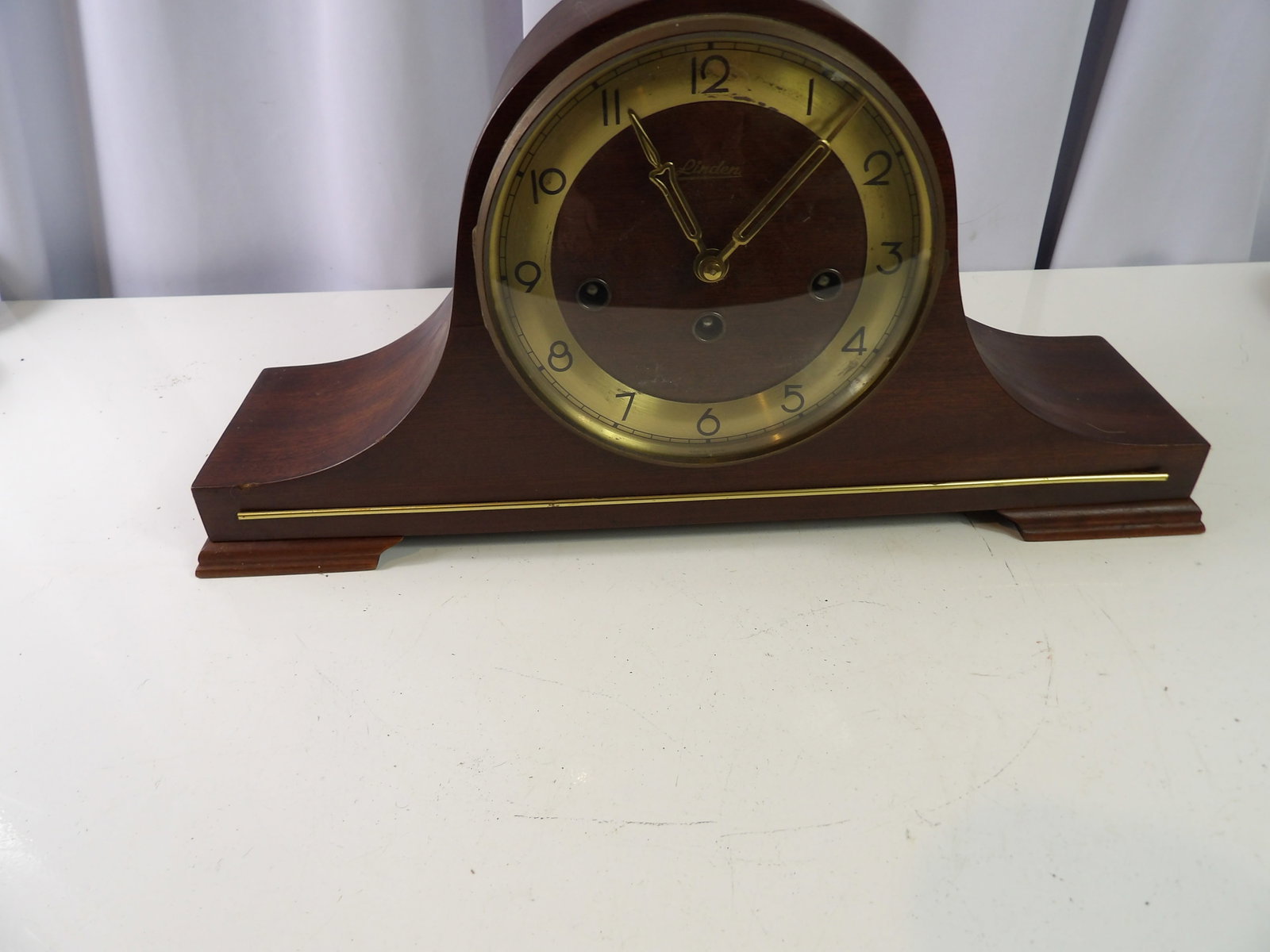 Vintage Linden German Chiming Mantel Clock: Vintage Linden German Chiming Mantel Clock with Brass Accents. All measurements approximate. Please see photos for condition and details. Selling as is from 04281.