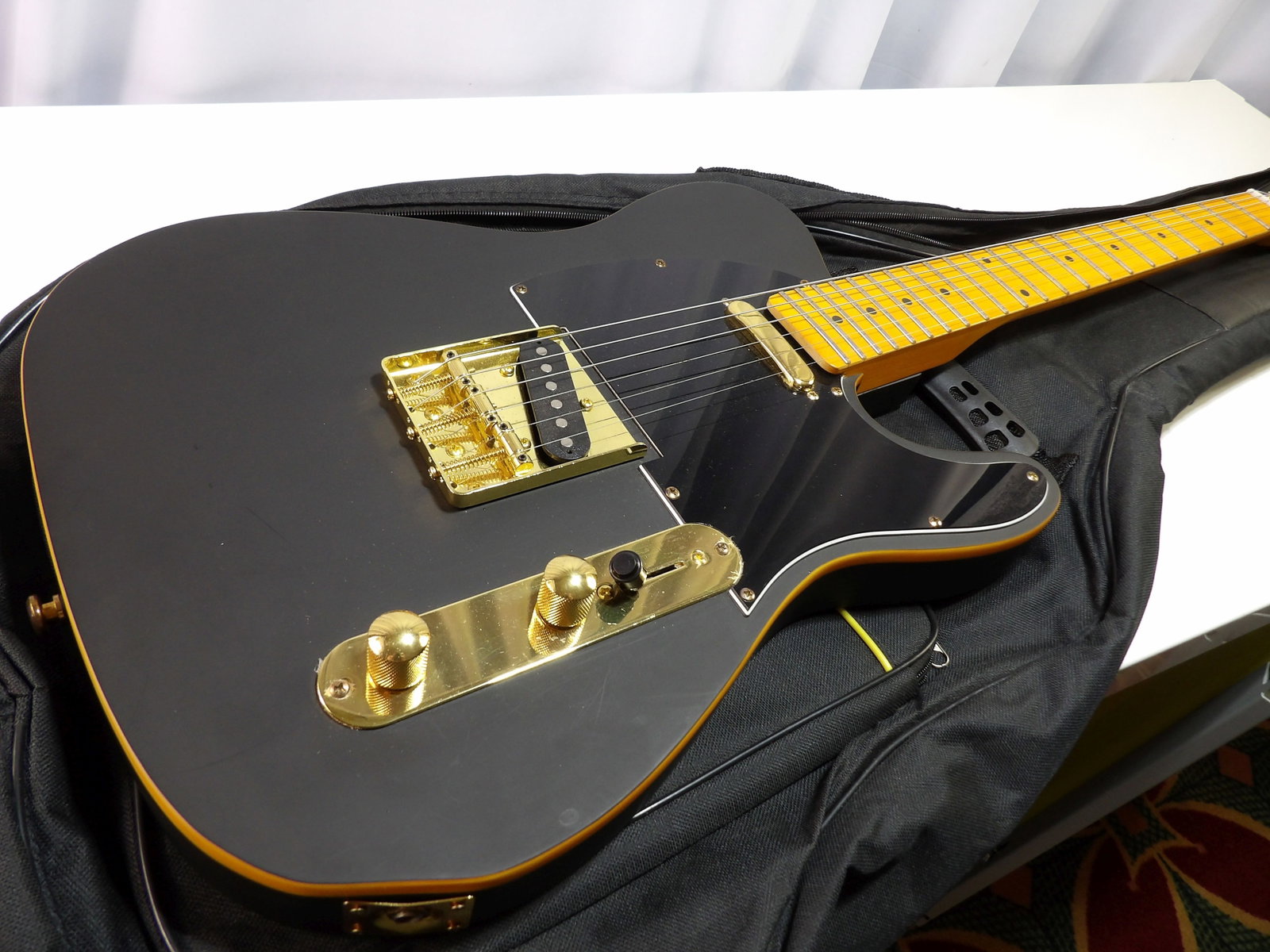 Matte Black Fender Telecaster Guitar with Gold Hardware: Fender Telecaster, Matte Black, with Gold Hardware and Soft Padded Case. In Excellent Condition. We are not guitar experts or musicians. This guitar is in like new condition with no visible damage. It