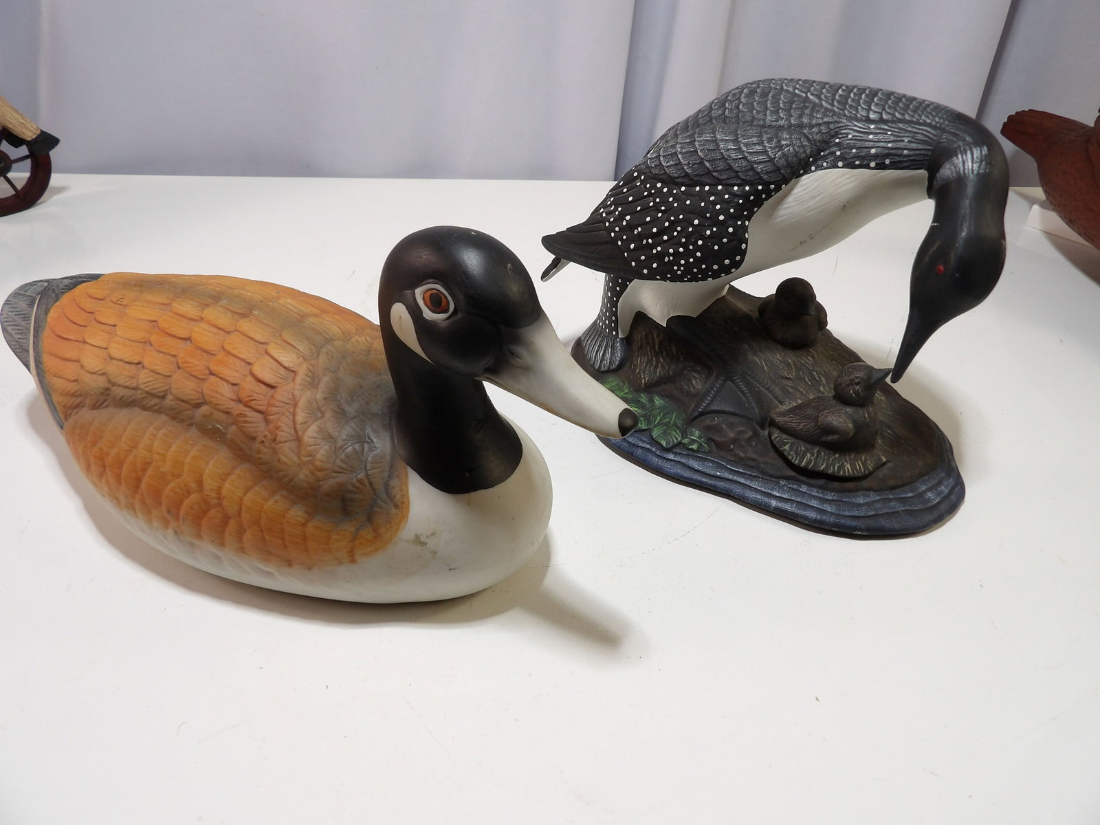 Pair of Ceramic Duck Figurines: Pair of Ceramic Duck and Loon Figurines. All measurements approximate. Please see photos for condition and details. Selling as is from 04281.