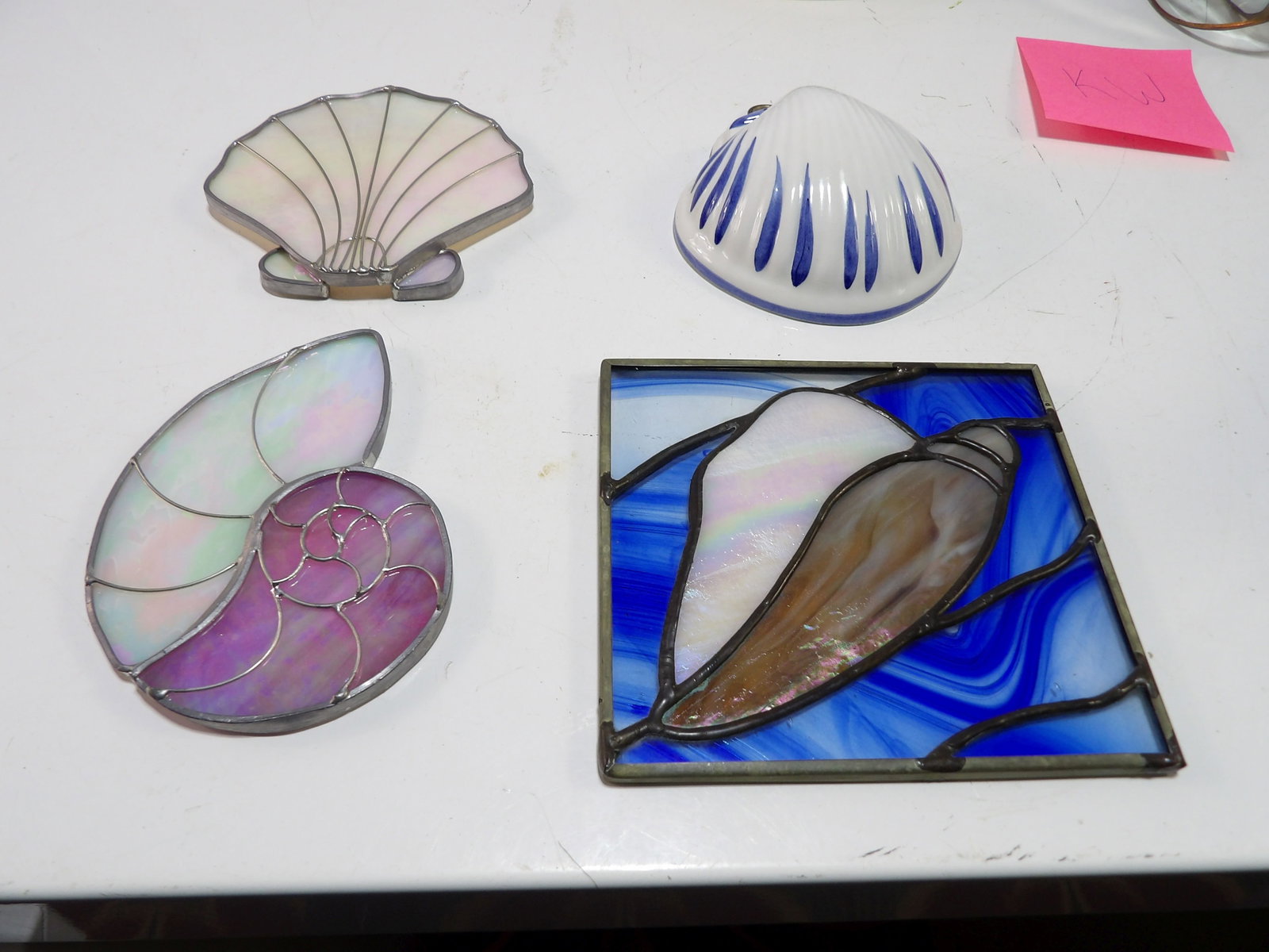 Stained Glass Suncatchers and Ceramic Shell Piece: Assorted Stained Glass Suncatchers and A Ceramic Bassano Shell Piece. All measurements approximate. Please see photos for condition and details. Selling as is from 04281.