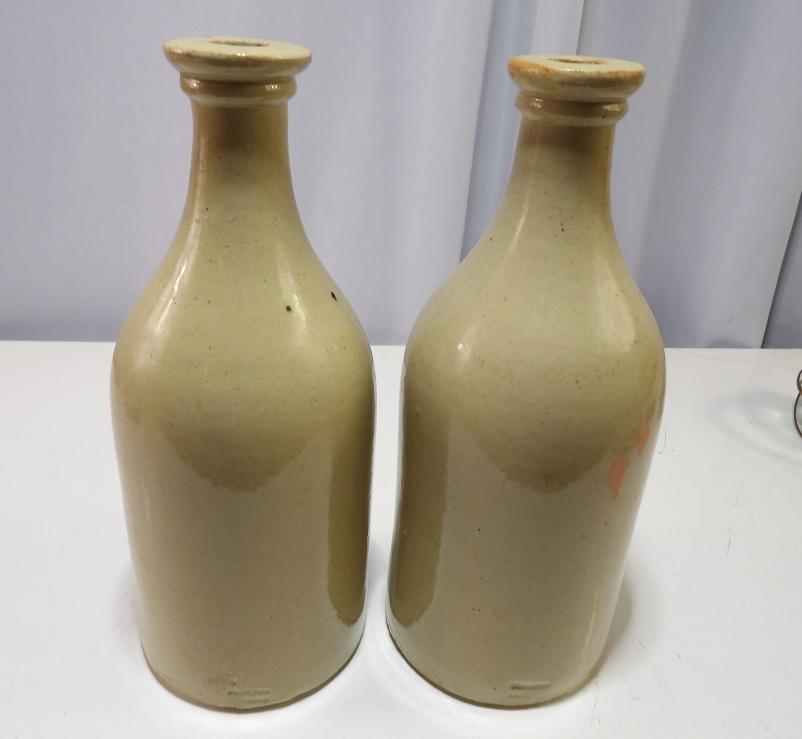 Pair of Salt Glazed Stoneware Bottles: Pair of Antique Salt Glazed Stoneware Bottles. Excellent Condition. All measurements approximate. Please see photos for condition and details. Selling as is from 04281.