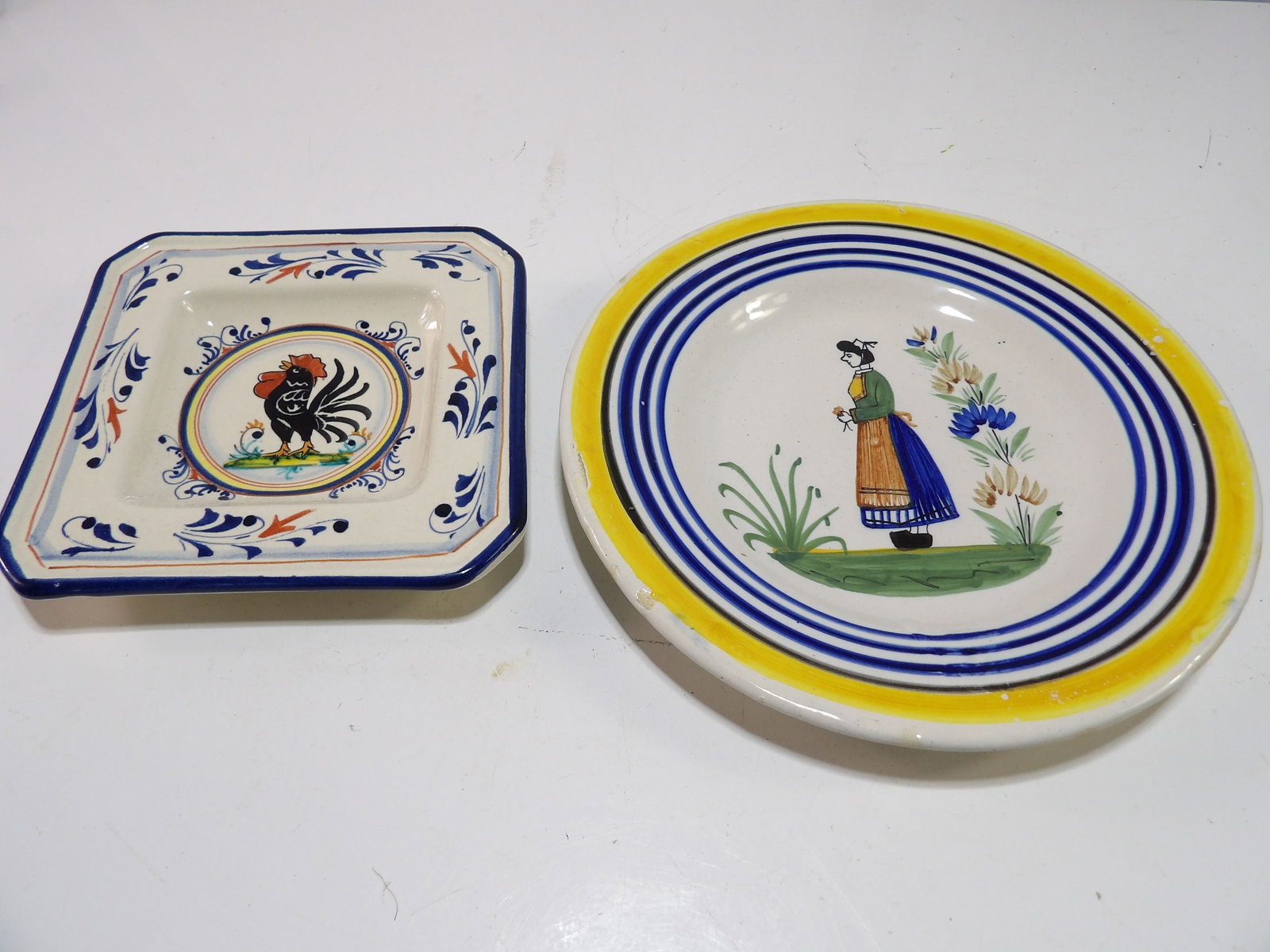 Pair of Henriot Quimper and Matteotti Majolica Decorative Plates: Henriot Quimper French Plate with Woman and Flowers and a Hand Painted Rooster Plate. Italian Matteotti Majolica. All measurements approximate. Please see photos for condition and details. Selling as 
