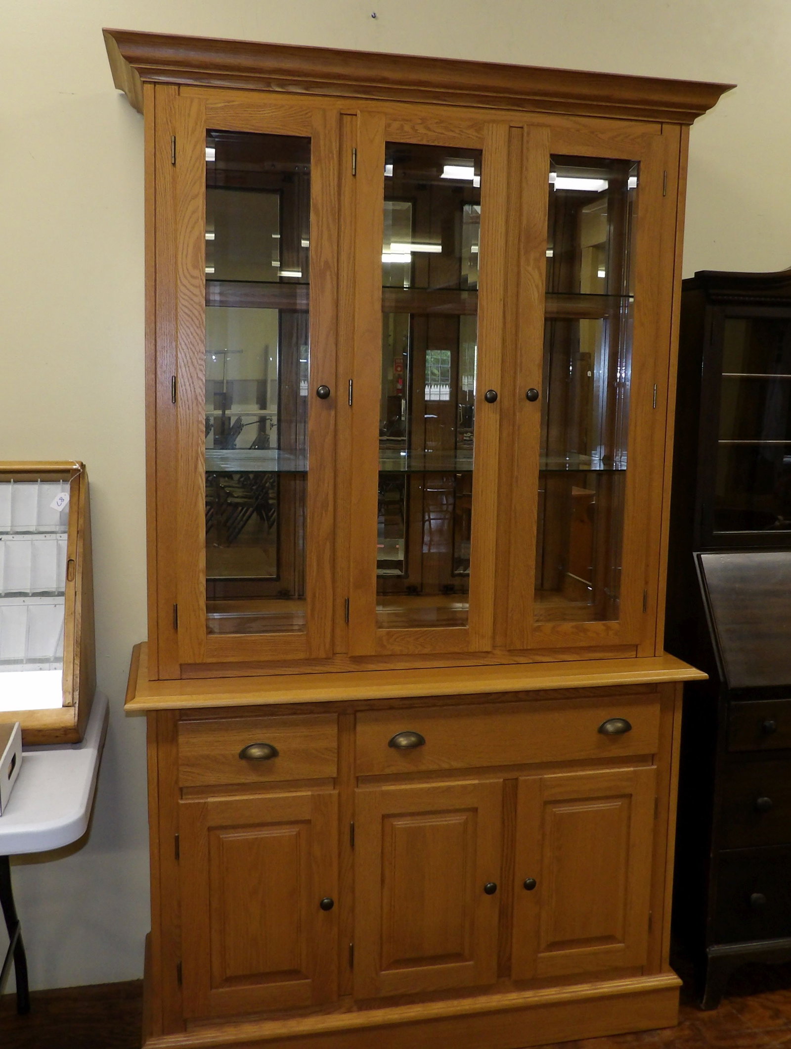 Solid Oak China Hutch with Glass Doors by Canadel: Solid Oak China Hutch with 3 Beveled Class Doors. Made in Canada by Canadel. Just a Beautiful Piece. All measurements approximate. Please see photos for condition and details. Selling as is from 04281
