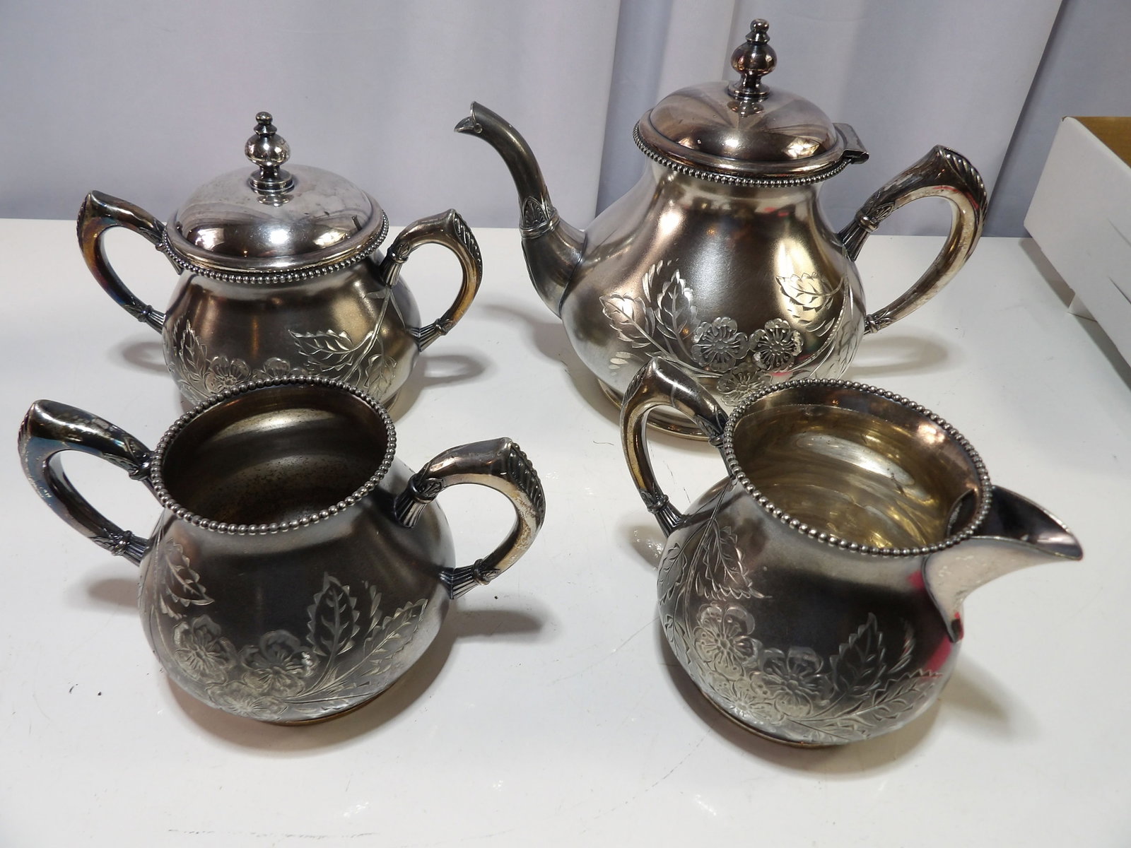 Rogers Silver Plated Tea Set: Vintage Rogers Silver Plated Tea Set with Floral Embossing. All measurements approximate. Please see photos for condition and details. Selling as is from 04281.
