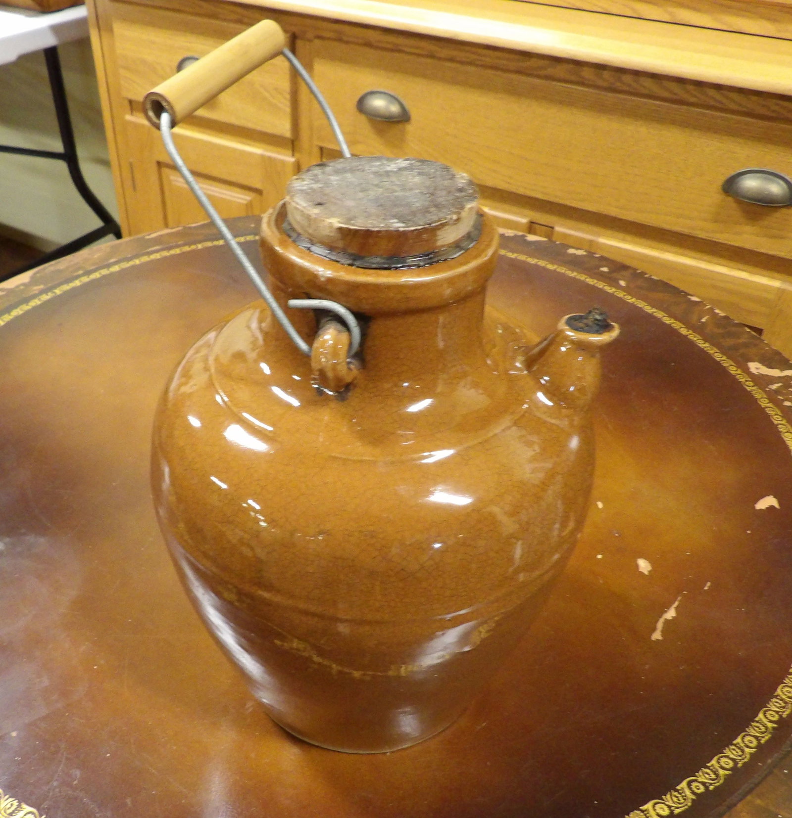 Brown Glazed Stoneware Jug: Antique Brown Glazed Stoneware Jug with Wire Handle and Cork Stopper. All measurements approximate. Please see photos for condition and details. Selling as is from 04281.
