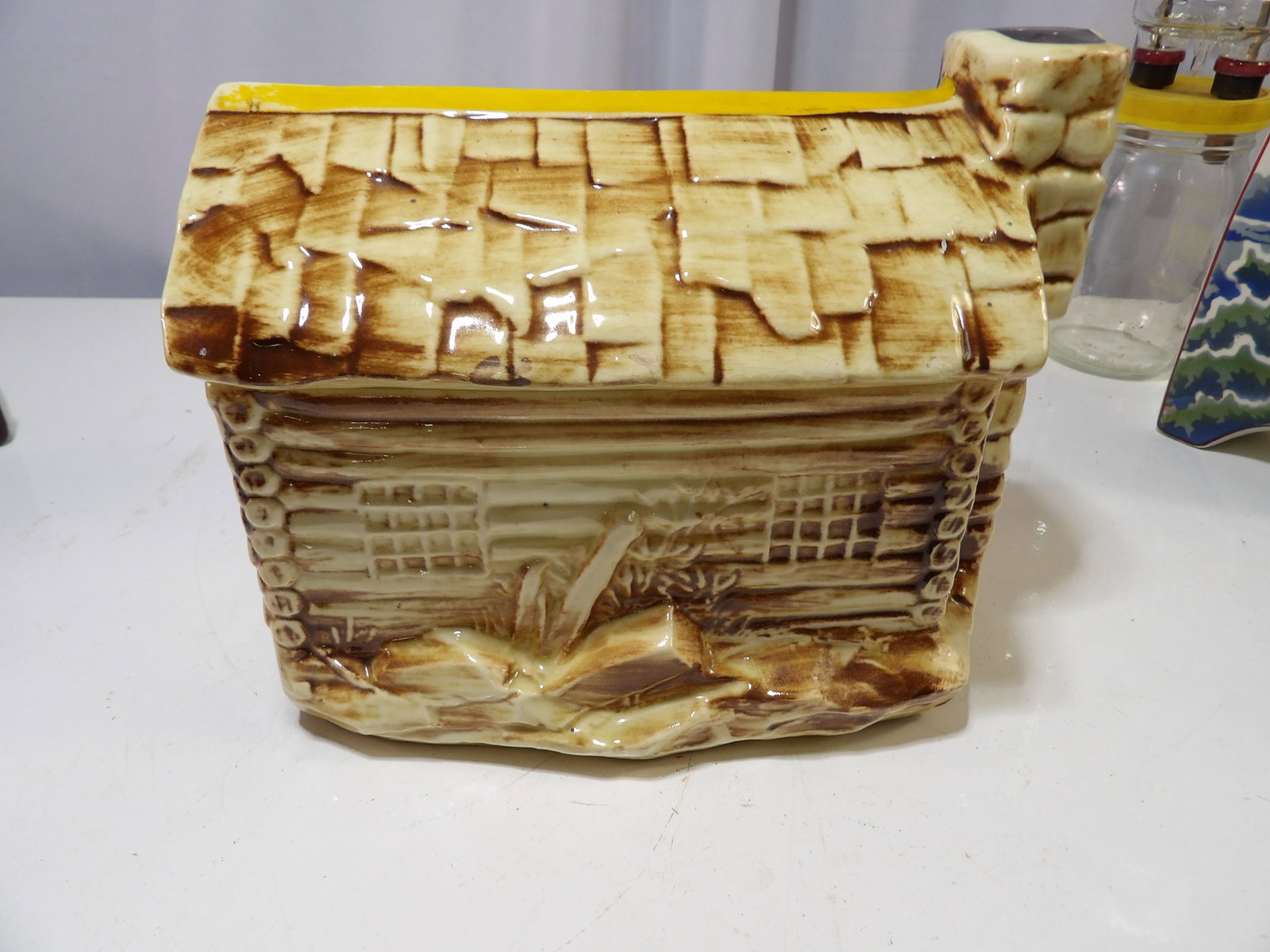 McCoy Log Cabin Cookie Jar: Vintage McCoy Log Cabin, Ceramic Cookie Jar, Model 136. All measurements approximate. Please see photos for condition and details. Selling as is from 04281.