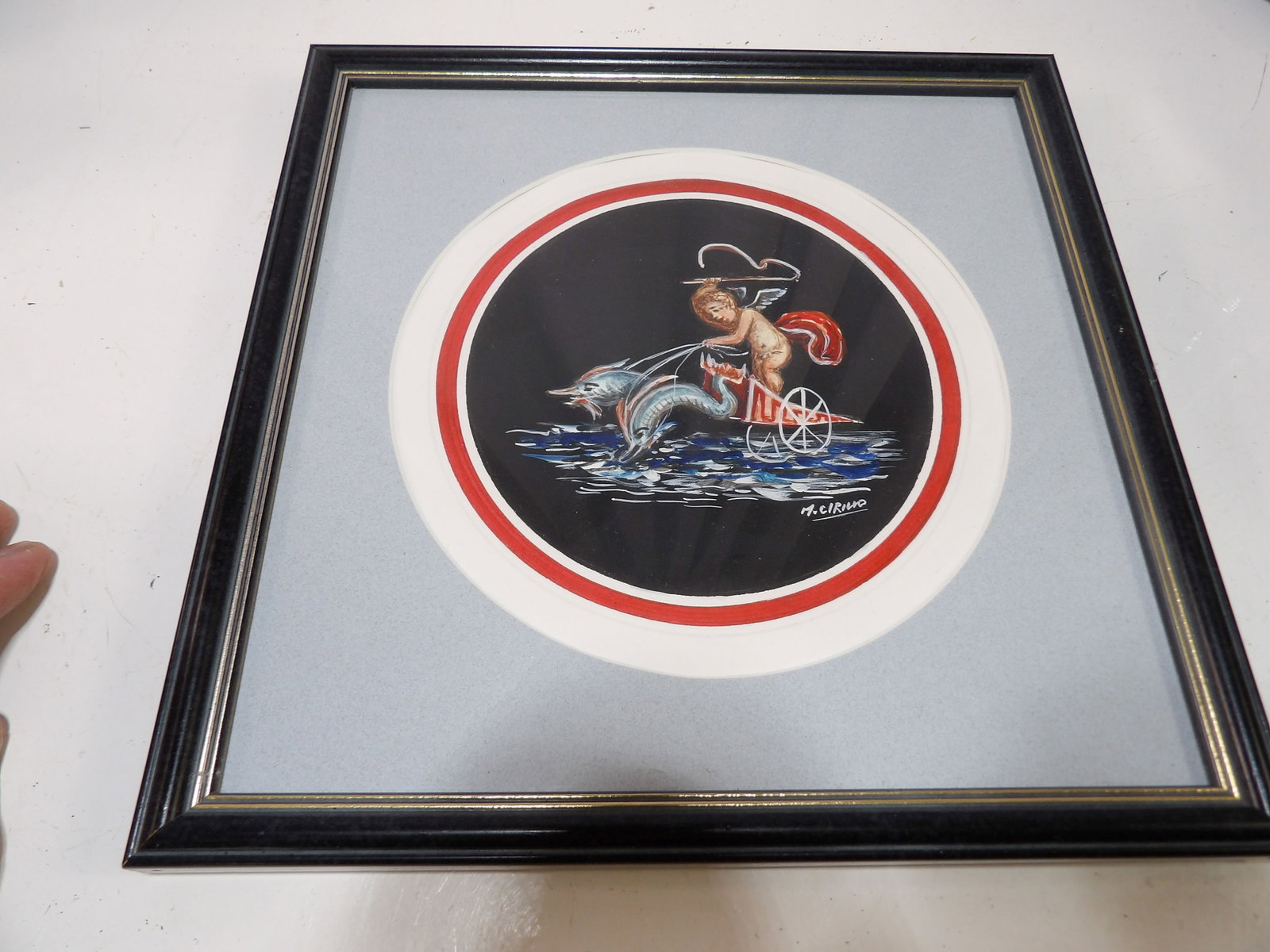 M. Cirillo Framed Painting of Cherub on Dolphin Chariot: M. Cirillo Framed Gouache Painting of Cherub on Dolphin Chariot. All measurements approximate. Please see photos for condition and details. Selling as is from 04281.