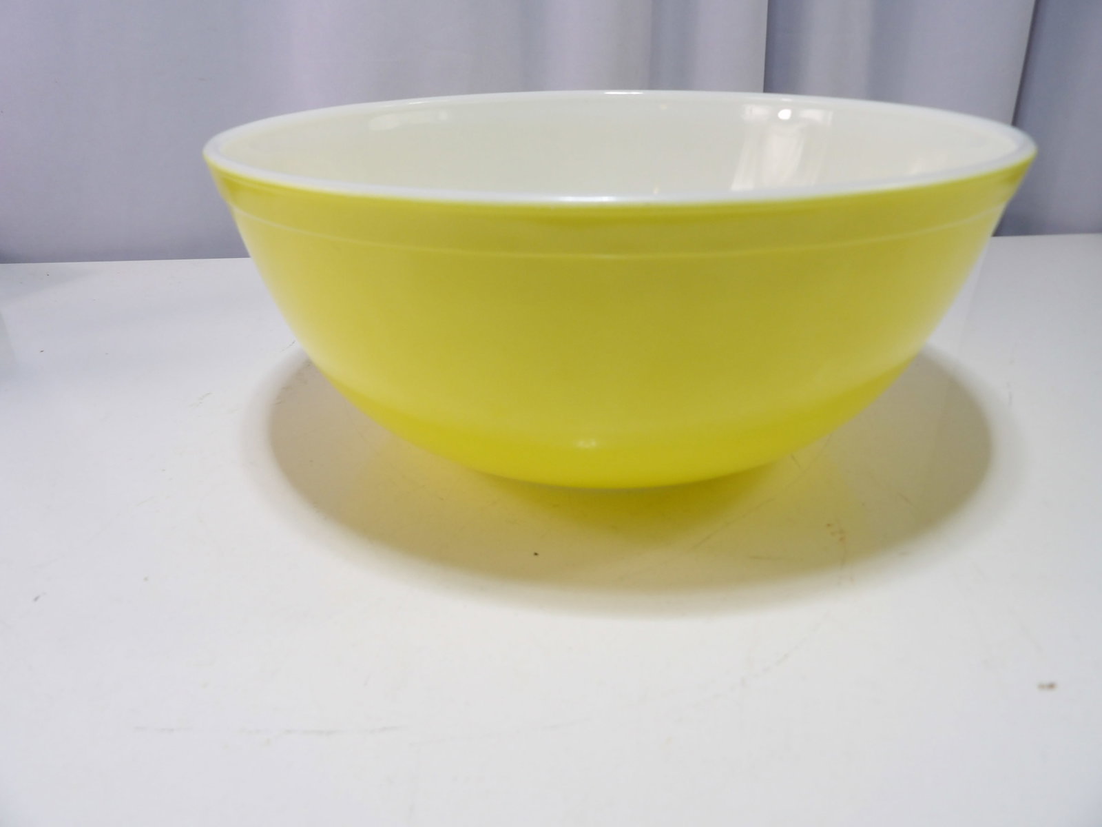 Vintage Pyrex Primary Yellow Mixing Bowl: Vintage Pyrex Primary Yellow Mixing Bowl #404, 4 Quart. All measurements approximate. Please see photos for condition and details. Selling as is from 04281.