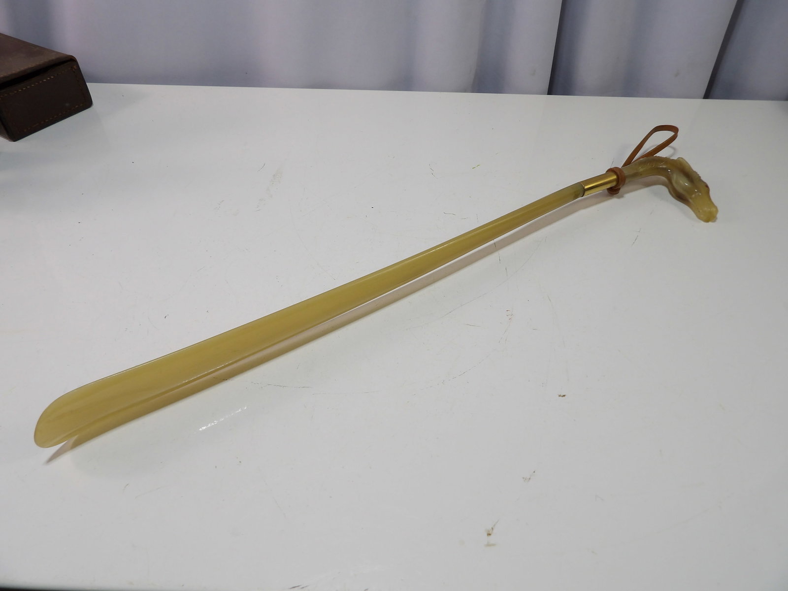 Long Handled Shoe Horn: Vintage Long Handled Shoe Horn with Horse Head. All measurements approximate. Please see photos for condition and details. Selling as is from 04281.