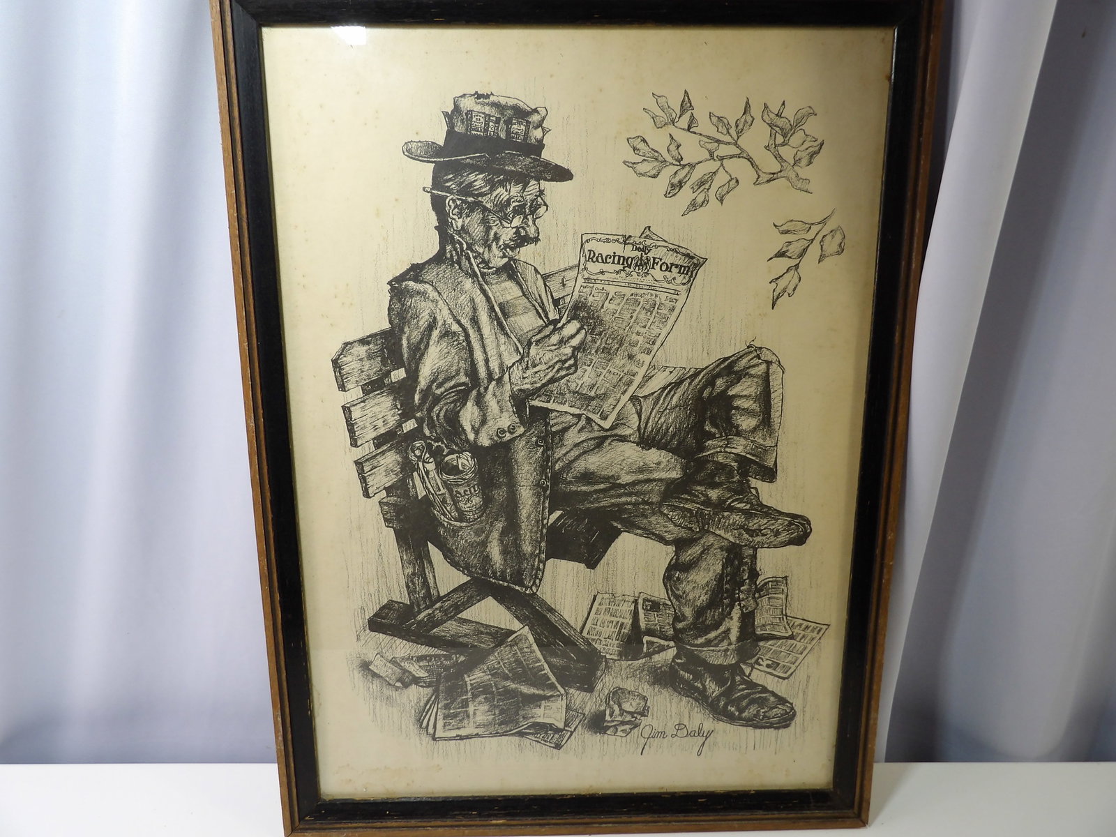 Signed Jim Daly Print, "Still Trying": Jim Daly Signed Print "Still Trying" depicting a Hobo Reading a Newspaper. 17" X 24". All measurements approximate. Please see photos for condition and details. Selling as is from 04281.