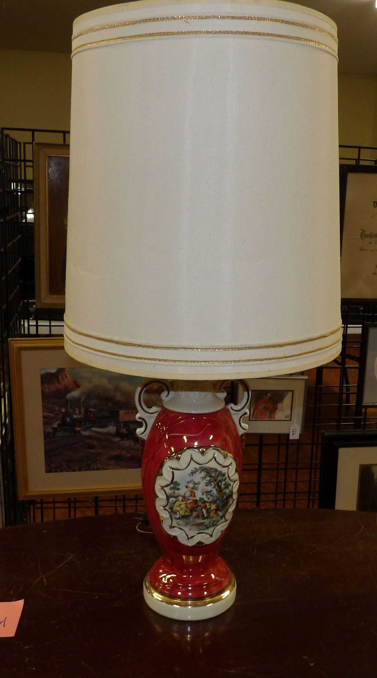 Red Porcelain Lamp with Courting Couple Scene: Vintage Red Porcelain Lamp with Courting Couple Scene. All measurements approximate. Please see photos for condition and details. Selling as is from 04281.
