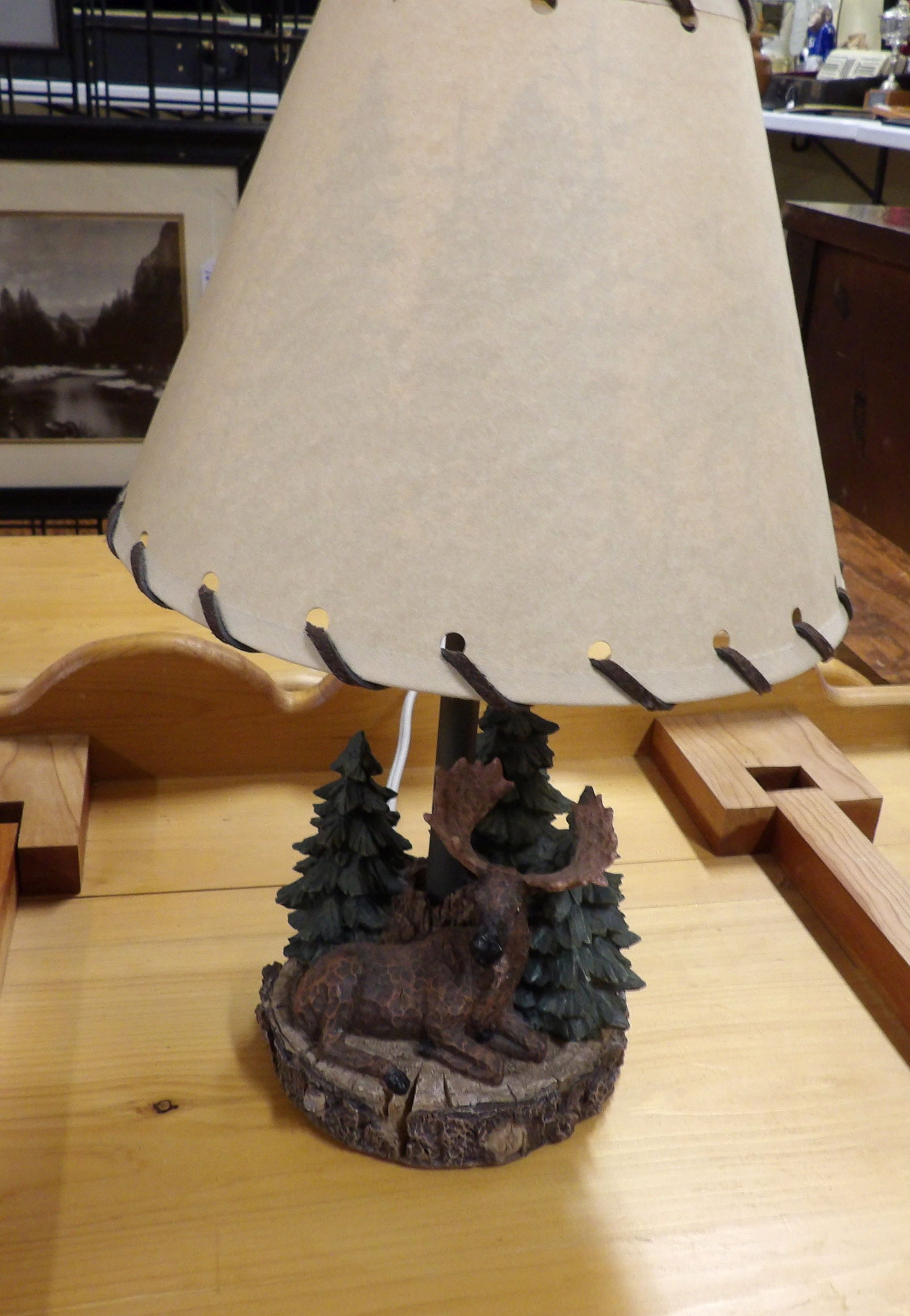 Lodge Style Table Lamp: Rustic Lodge Style Table Lamp with a Moose and Pine Tree Base. All measurements approximate. Please see photos for condition and details. Selling as is from 04281.