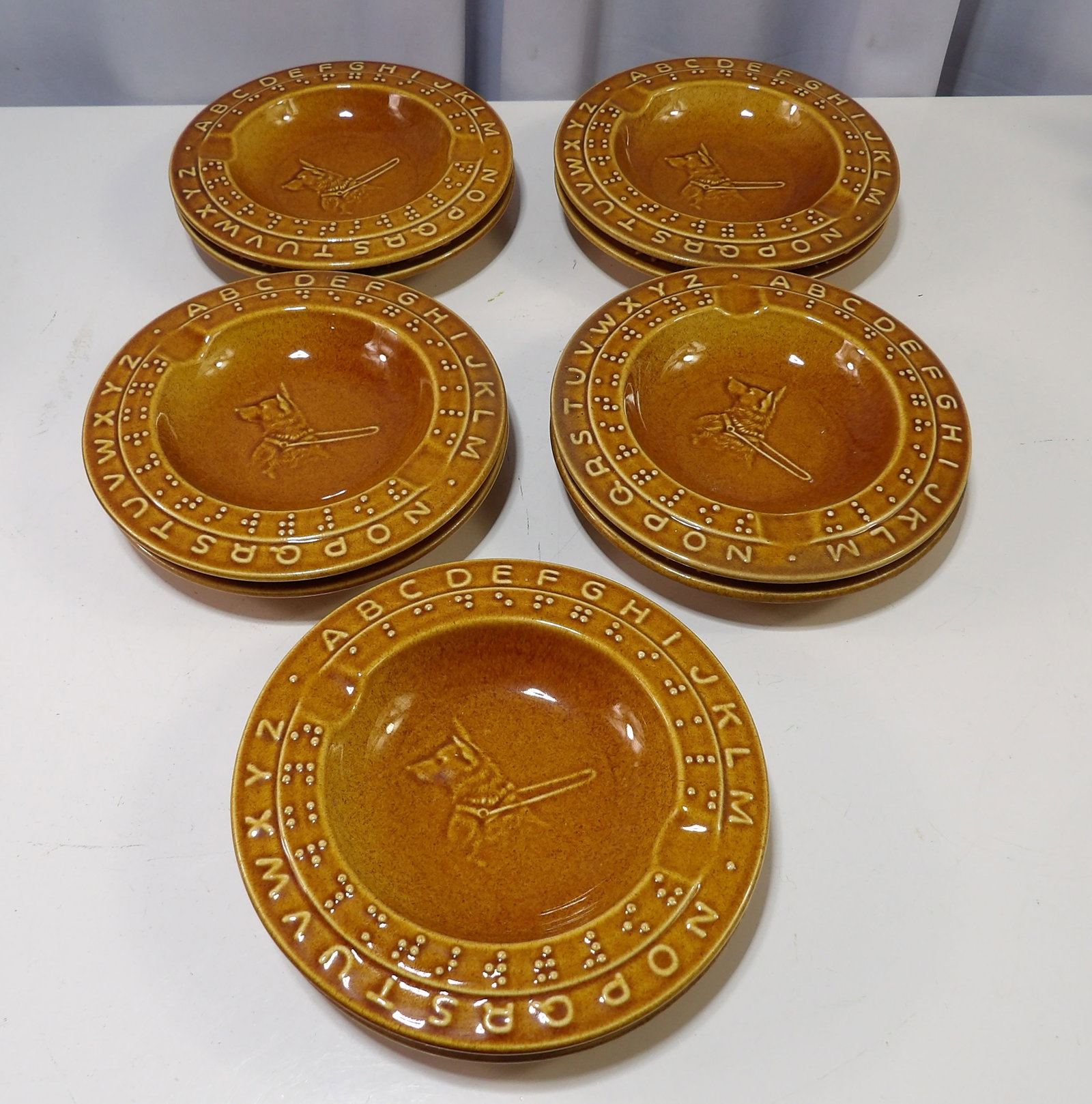 Set of 10 Braille Alphabet and Seeing Eye Dog Ashtrays: Set of 10 Vintage Braille Alphabet and Seeing Eye Dog Ceramic Ashtrays. All measurements approximate. Please see photos for condition and details. Selling as is from 04281.