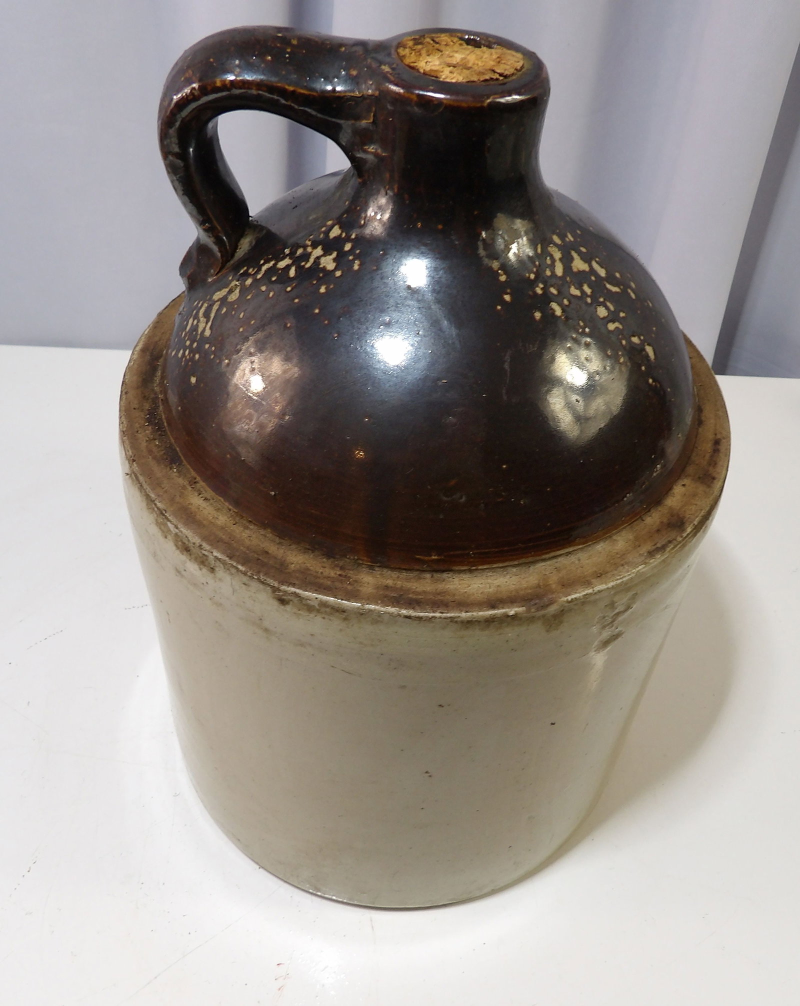 Brown Stoneware Jug with Handle and Cork: Vintage Brown Stoneware Jug with Handle and Cork. All measurements approximate. Please see photos for condition and details. Selling as is from 04281.