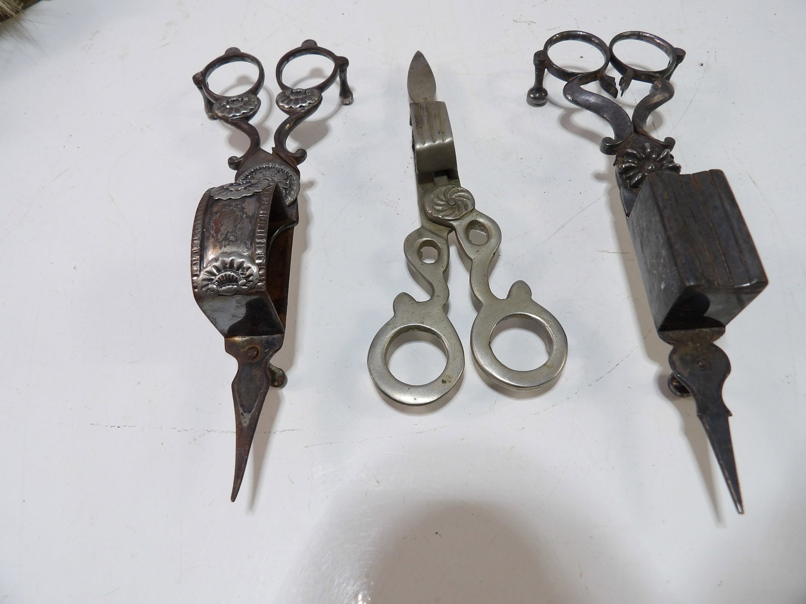 Collection of 3 Metal Candle Wick Trimmers: Collection of 3 Antique Metal Candle Wick Trimmers. All measurements approximate. Please see photos for condition and details. Selling as is from 04281.