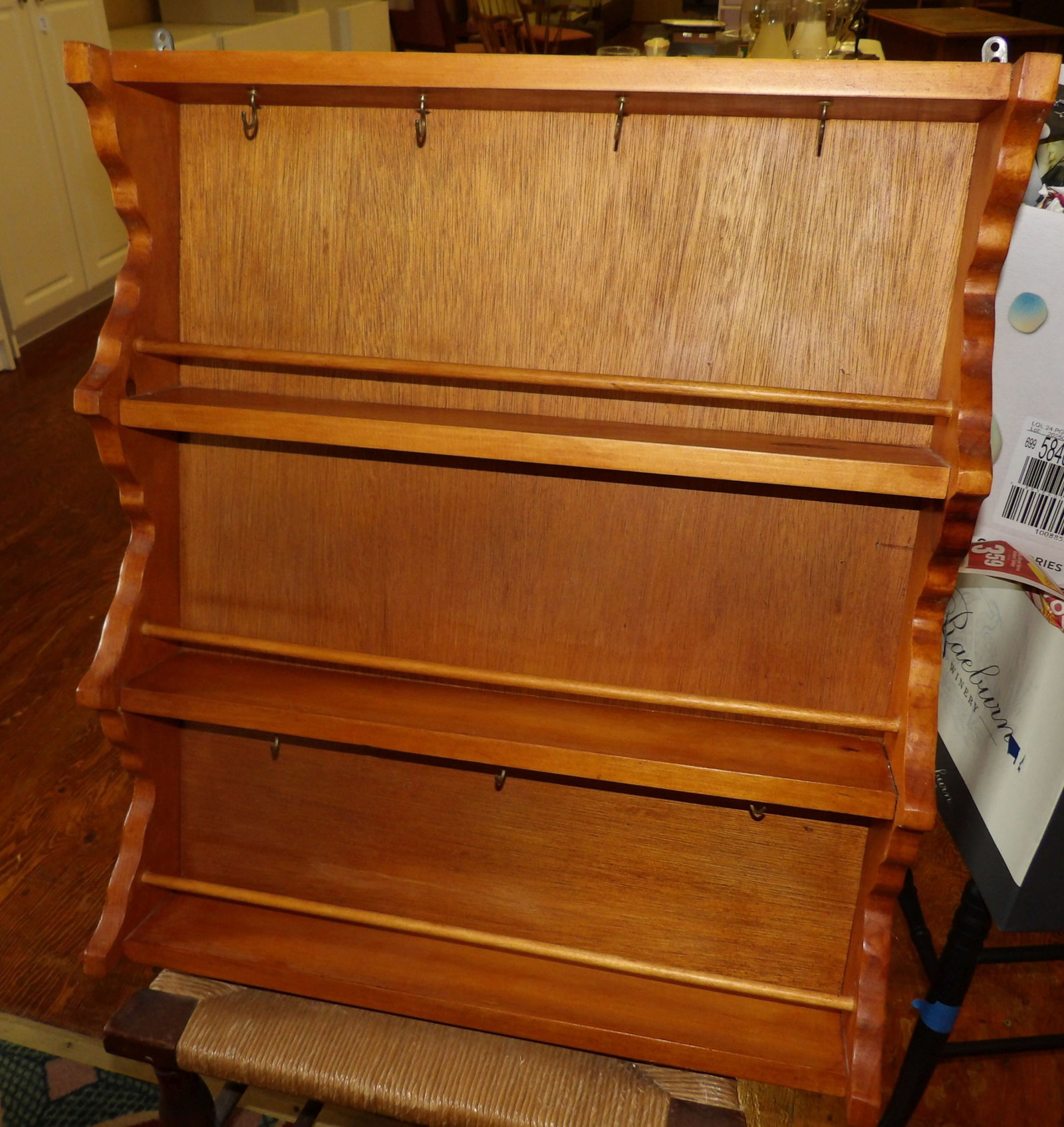 Wooden 3-Tiered Wall Shelf: Vintage Wooden Wall Shelf with 3 Tiers, Scalloped Sides and hanging Hooks. 23" Wide X 26" High. All measurements approximate. Please see photos for condition and details. Selling as is from 04281.
