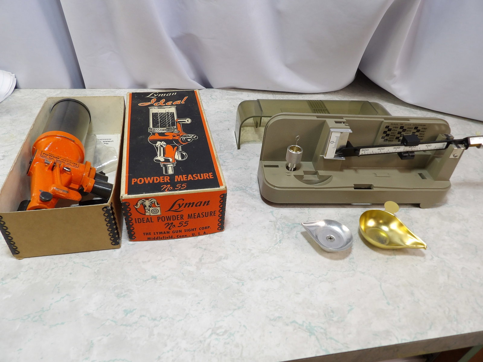 Lyman Ideal Powder Measure and Ohaus Conversion Scale: Vintae Lyman Idea No. 55 Powder Measure in Original Box and Ohaus 10.10 Ounce to Grain Conversion Scale. All measurements approximate. Please see photos for condition and details. Selling as is from