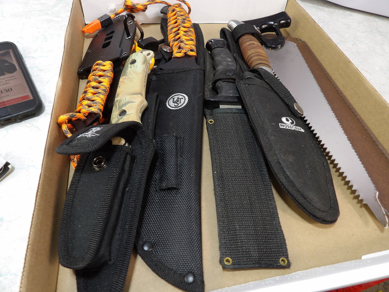 Collection of Survival Tools: Collection of Survival Tools, including Machetes, Knives and Saw with Sheath. All measurements approximate. Please see photos for condition and details. Selling as is from 04281.