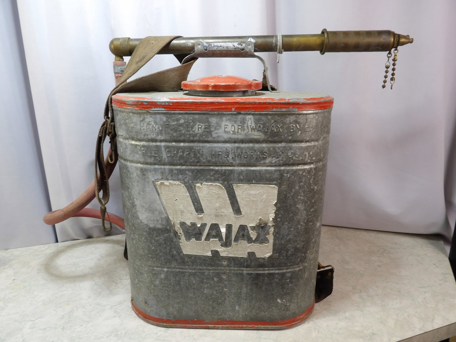 Vintage Wajax Back Pack Water Tank Fire Extinguisher: Vintage Wajax Back Pack Water Tank Fire Extinguisher with Brass Pump. All measurements approximate. Please see photos for condition and details. Selling as is from 04281.