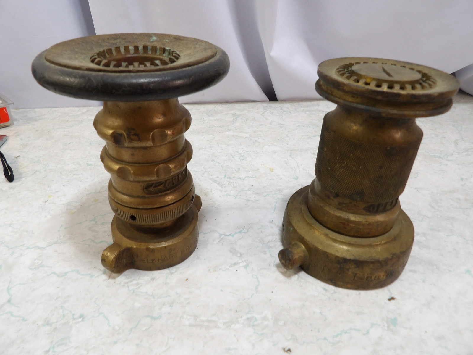 Pair of Elhart Brass Firehose Nozzles: Pair of Vintage Elkhart Brass Firehose Nozzles. All measurements approximate. Please see photos for condition and details. Selling as is from 04281.