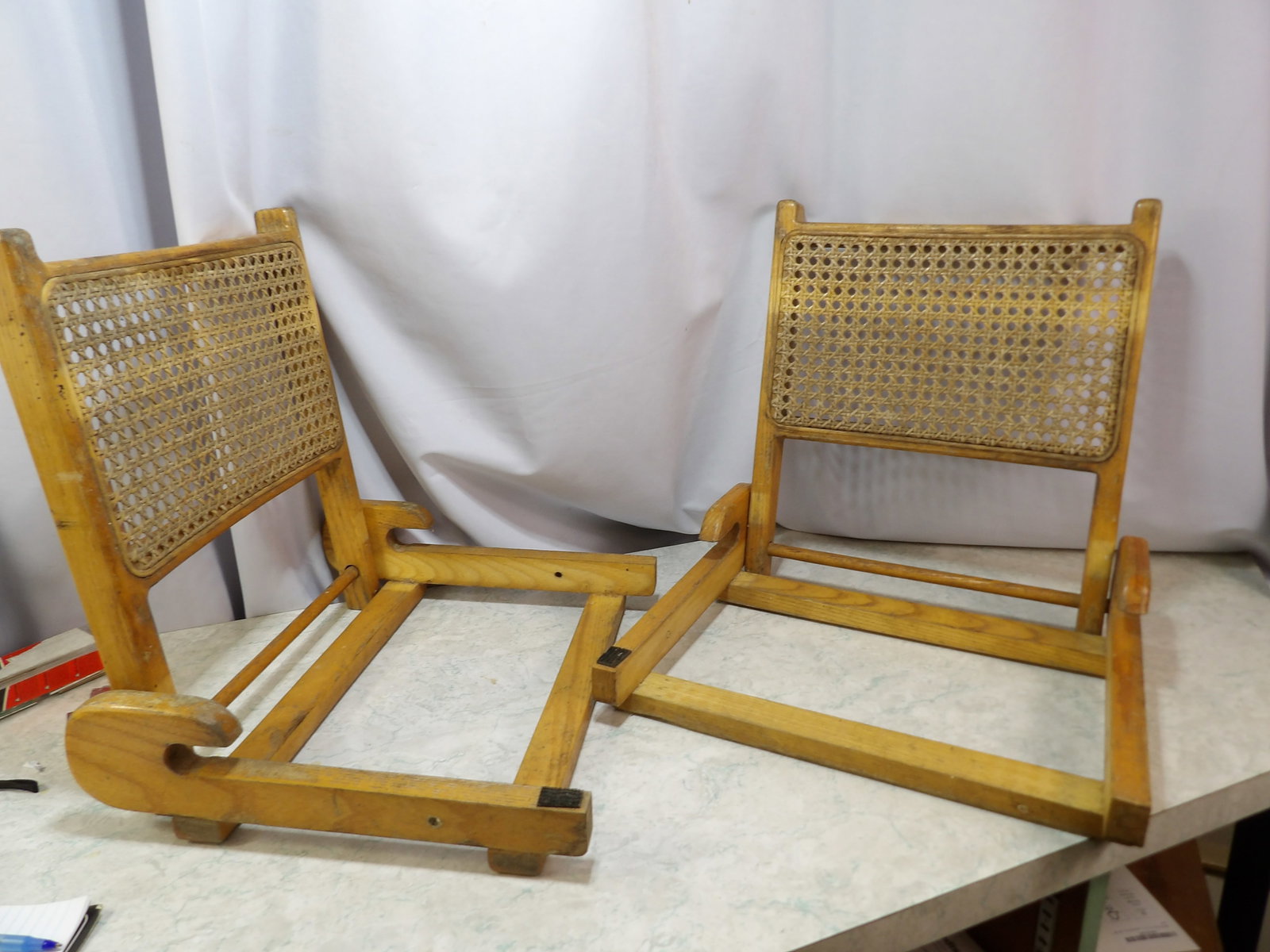 Pair of Folding Canoe Chairs with Backrests: Pair of Vintage Folding Ash and Cane Canoe Chairs with Backrests. All measurements approximate. Please see photos for condition and details. Selling as is from 04281.