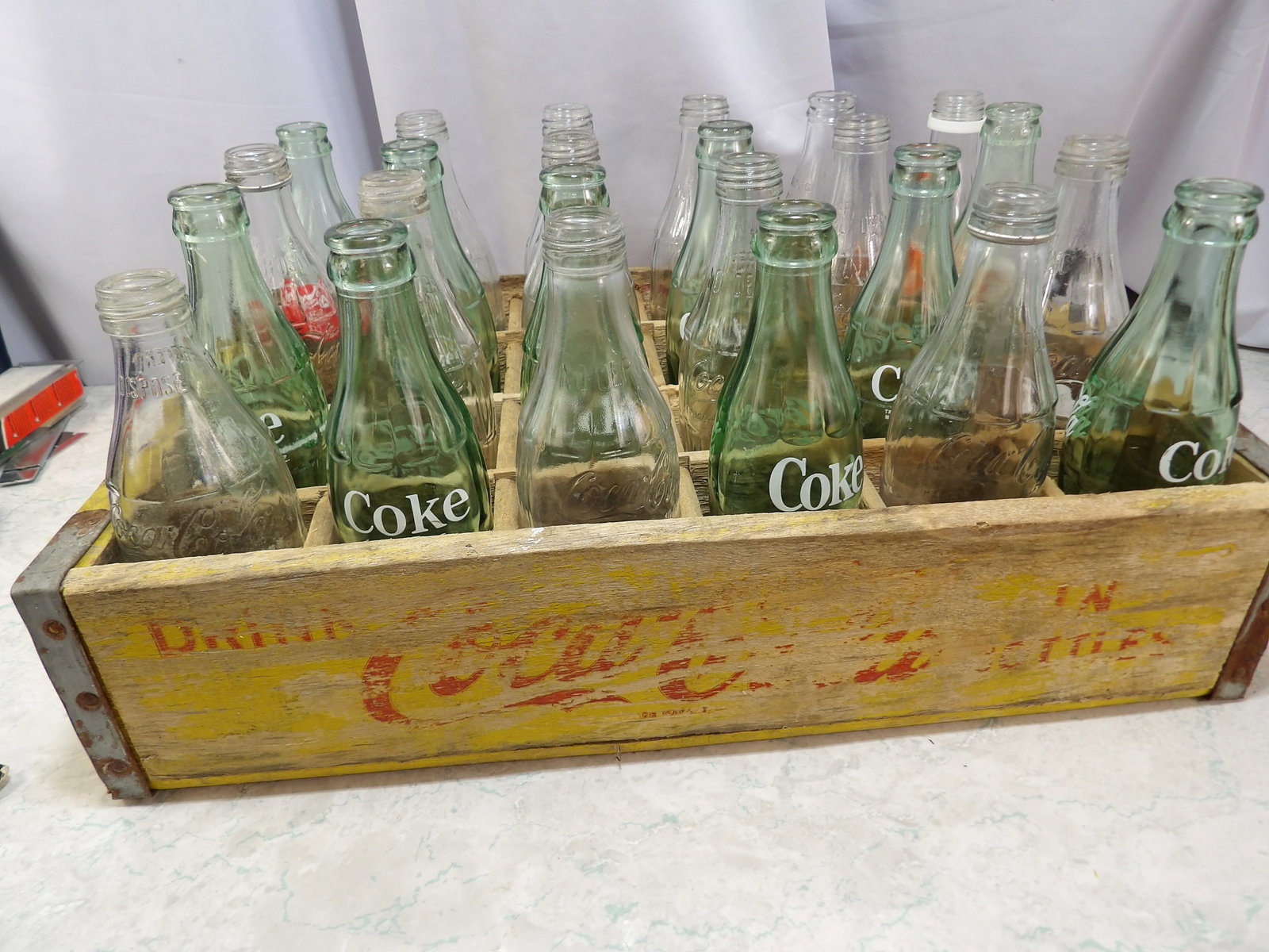 Coca-Cola Bottles in Wooden Crate: Vintage Coca-Cola Bottles in a Wooden Crate. Full Set of 24. All measurements approximate. Please see photos for condition and details. Selling as is from 04281.