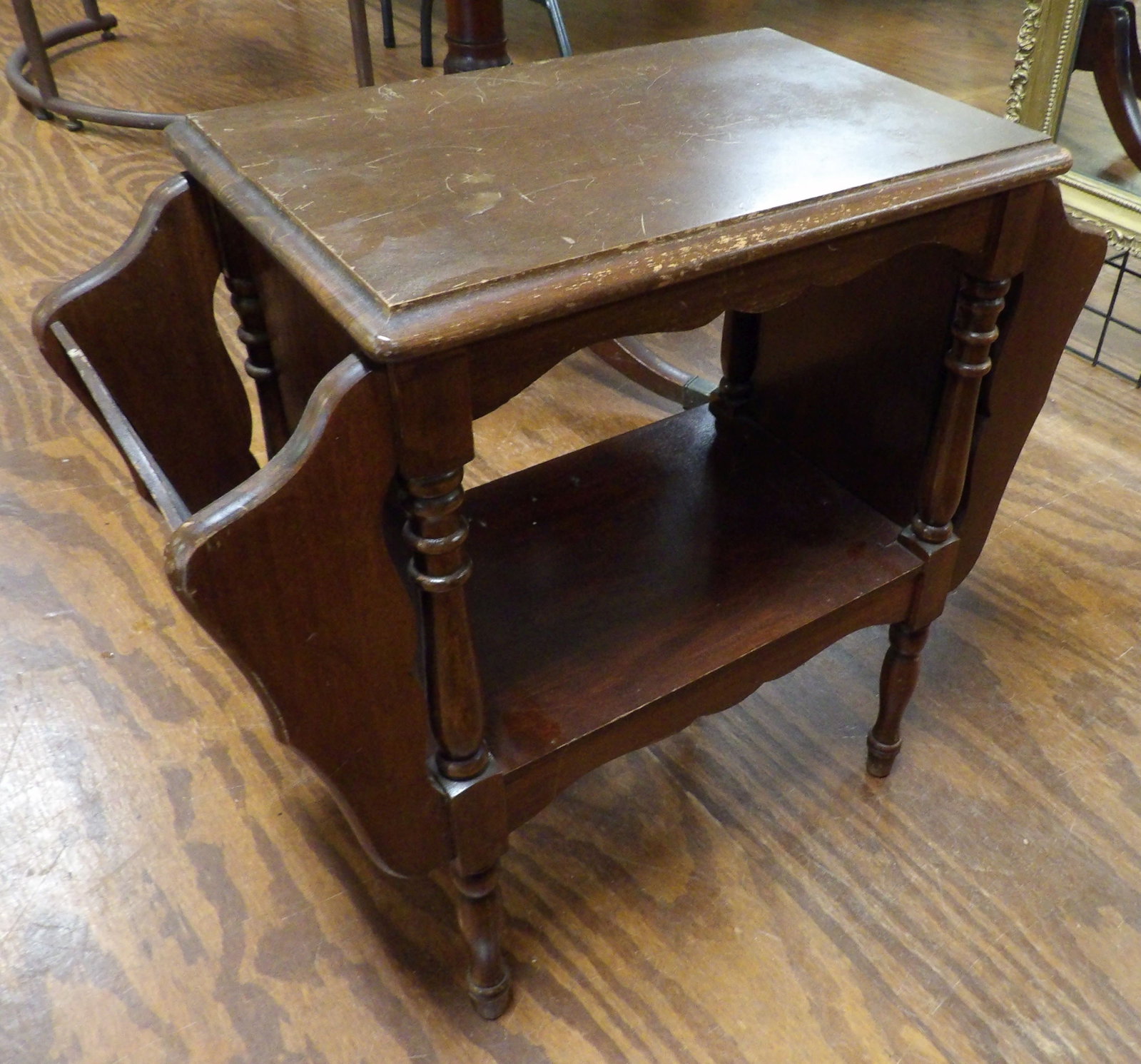 2 Tiered Wooden End Table with Magazine Rack: Vintage 2 Tiered Wooden End Table with Integrated Magazine Rack. All measurements approximate. Please see photos for condition and details. Selling as is from 04281.