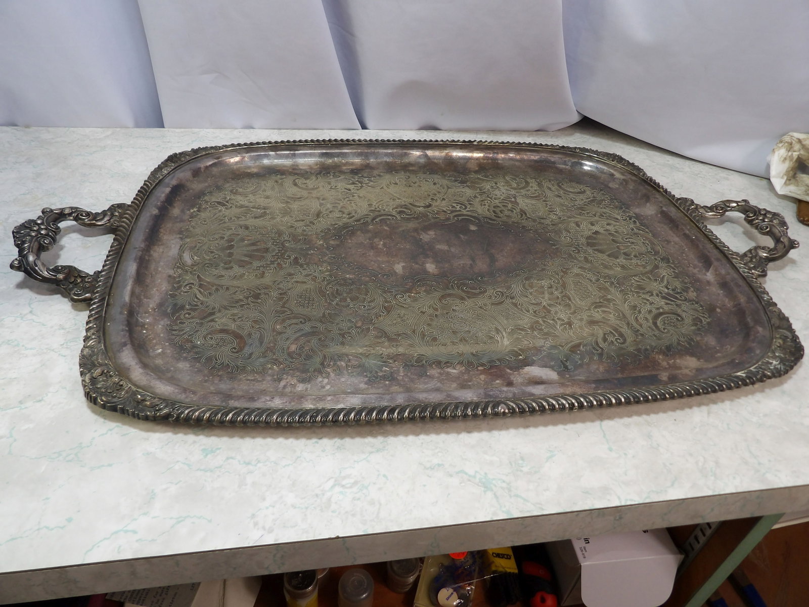 Ornated Silver Plated Rectangular Serving Tray: Vintage Ornate Silver Plated Rectangular Serving Tray with Handles. "Heavy", 16" X 22". Along with LiveShip (handled by LiveAuctioneers), we also can have a local shipper package and ship your