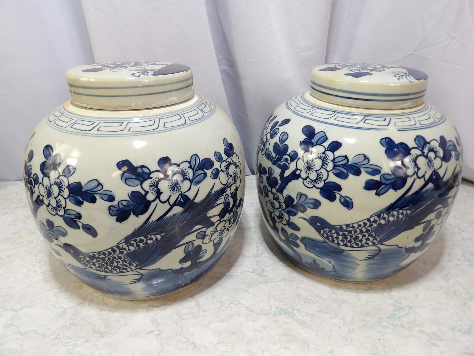 Pair of Chinese Porcelain Ginger Jars: Pair of Chinese Blue and White Porcelain Ginger Jars with Bird Motifs. 9" Tall. Along with LiveShip (handled by LiveAuctioneers), we also can have a local shipper package and ship your purchases. Just