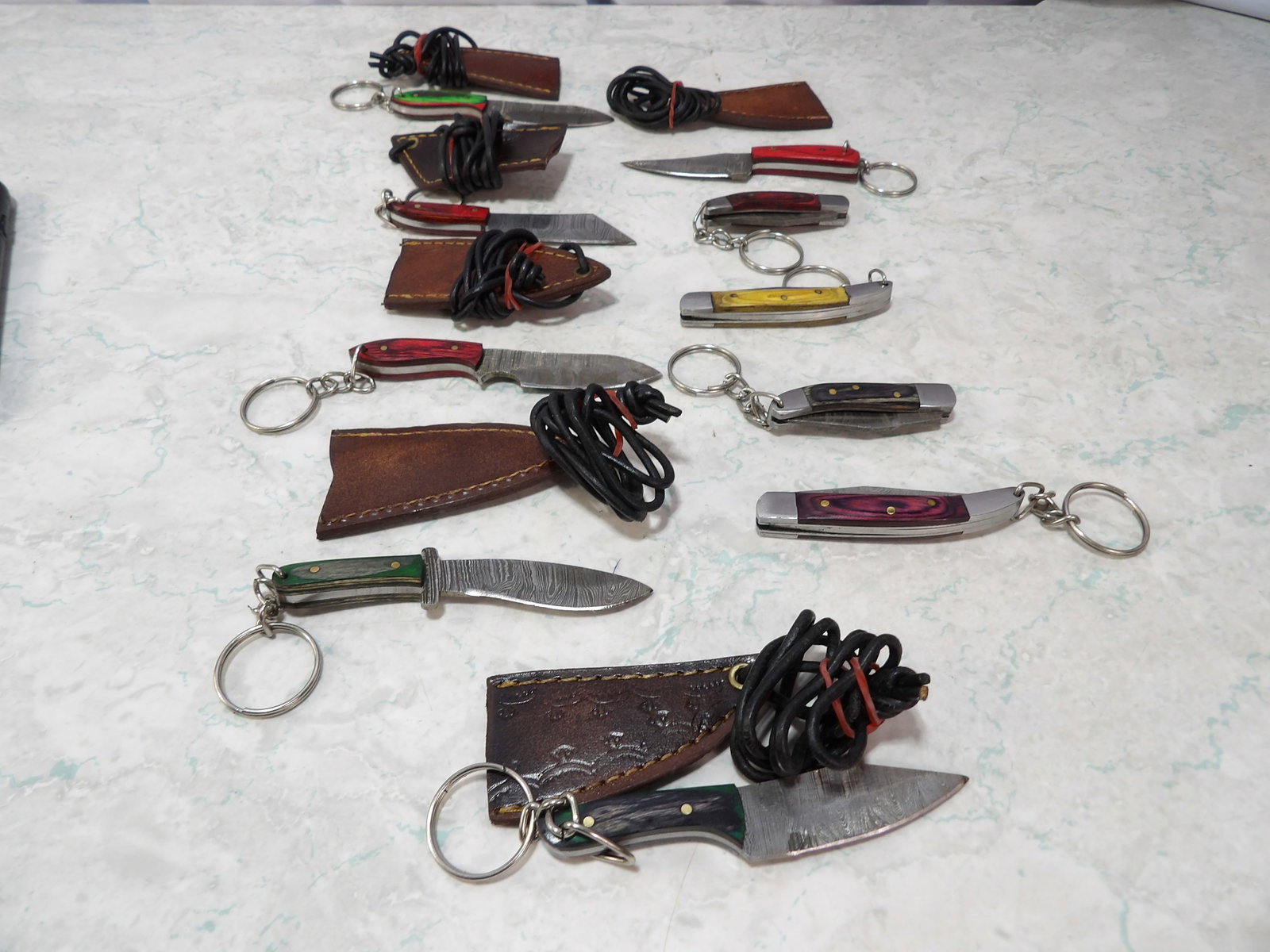 Collection of 10 Damascus Steel and Fixed Folding Knives: Collection of 10 Handmade Damascus Steel and Fixed Folding Knives. Along with LiveShip (handled by LiveAuctioneers), we also can have a local shipper package and ship your purchases. Just choose buyer