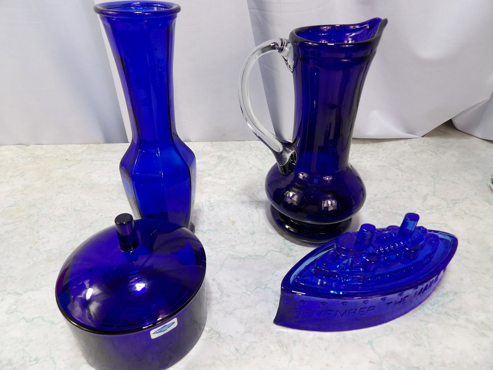 Collection of 4 Cobalt Blue Decorative Items: Collection of 4 Vintage Cobalt Blue Decorative Items. Along with LiveShip (handled by LiveAuctioneers), we also can have a local shipper package and ship your purchases. Just choose buyer arranges