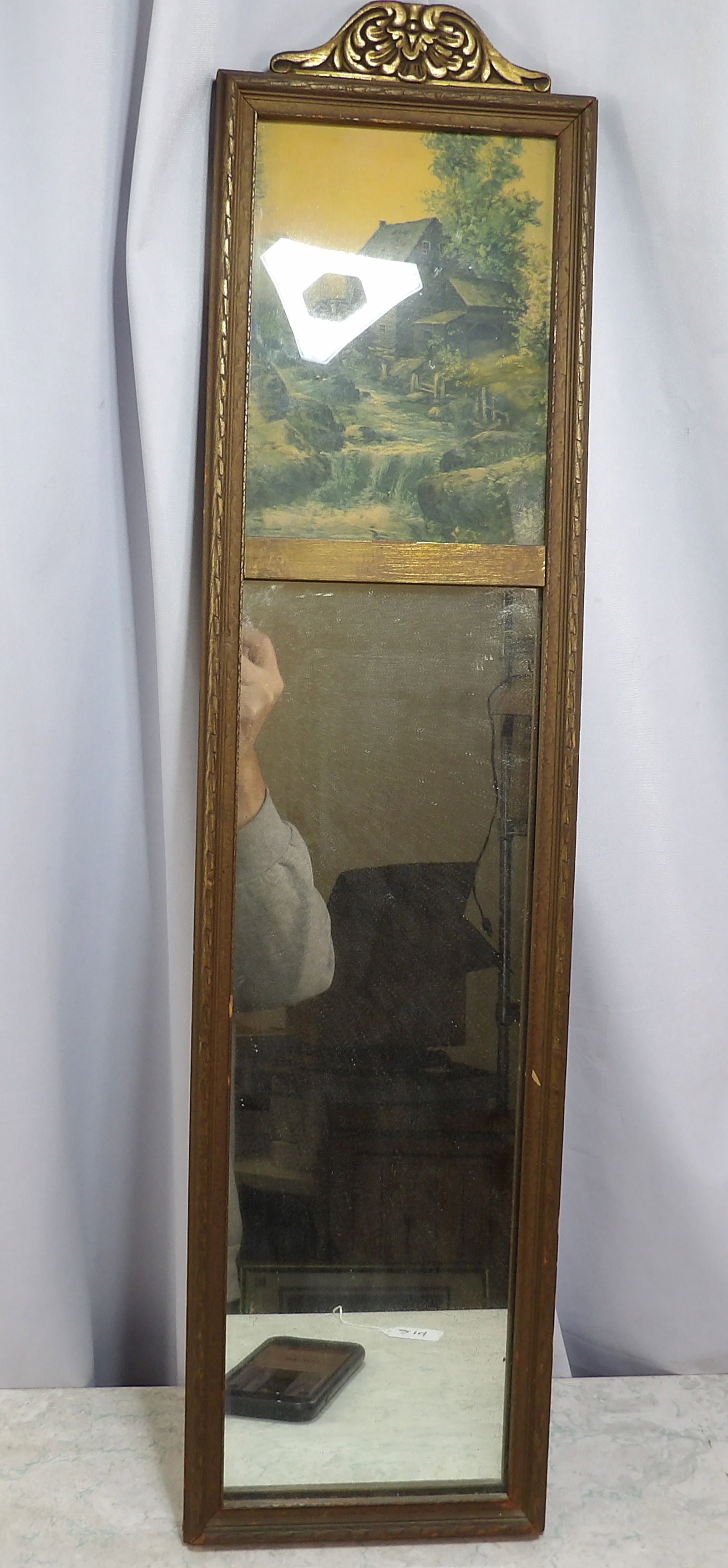 Wooden Trumeau Mirror with Landscape Print: Antique Wooden Trumeau Mirror With Landscape Print. 7" X 29". Along with LiveShip (handled by LiveAuctioneers), we also can have a local shipper package and ship your purchases. Just choose buyer