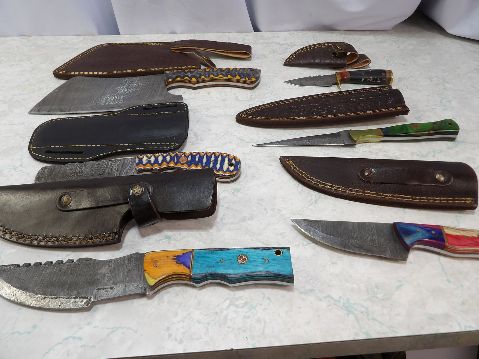 Lot of 6 Damascus Steel Knives with Sheaths: Lot of 6 Damascus Steel Knives with leather Sheaths. Along with LiveShip (handled by LiveAuctioneers), we also can have a local shipper package and ship your purchases. Just choose buyer arranges