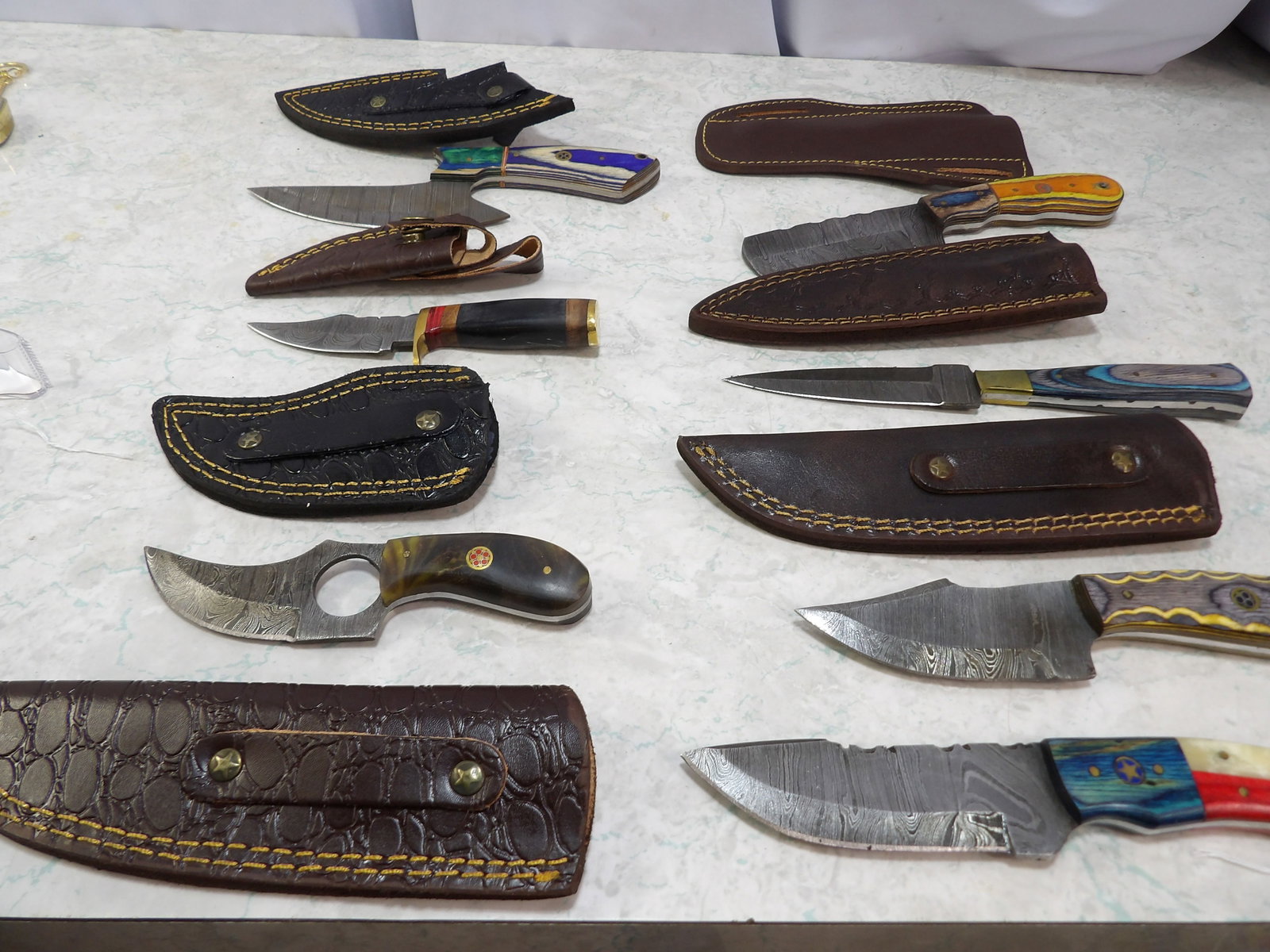 Lot of 7 Damascus Steel Knives with Leather Sheaths: Lot of 7 Handmade Damascus Steel Knives with Leathers Sheaths. Along with LiveShip (handled by LiveAuctioneers), we also can have a local shipper package and ship your purchases. Just choose buyer