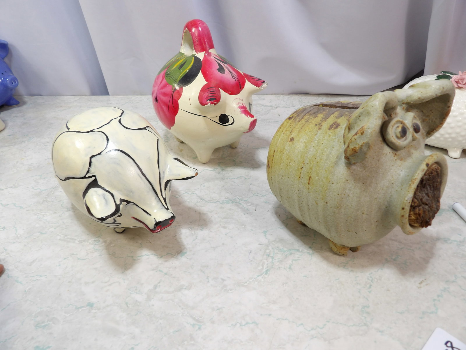 Collection of 3 Pottery Piggy Banks: Collection of 3 Vintage Folk Art Pottery Piggy Banks. Along with LiveShip (handled by LiveAuctioneers), we also can have a local shipper package and ship your purchases. Just choose buyer arranges