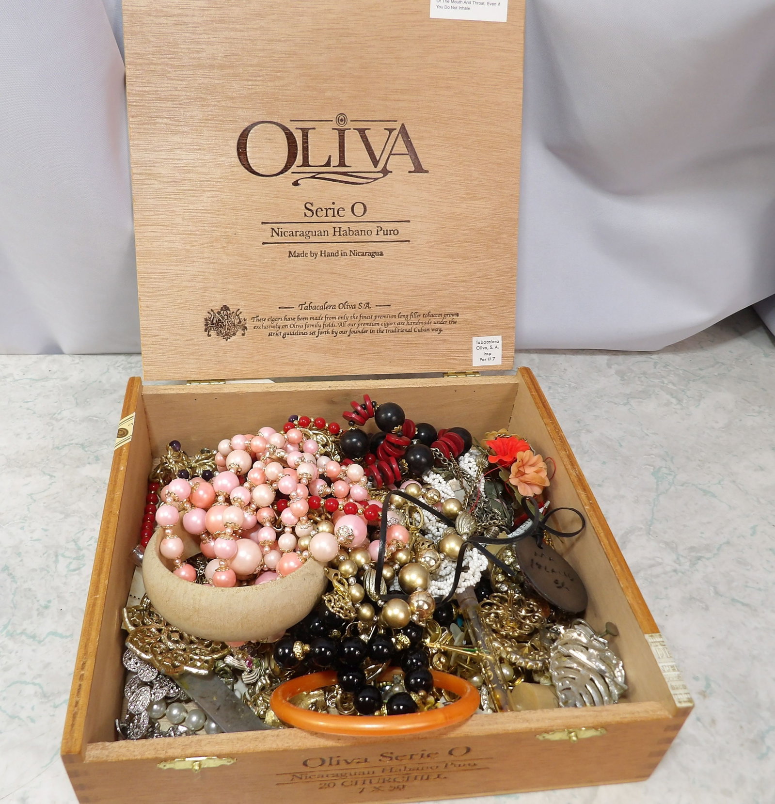 Assorted Costume Jewelry Lot: Assorted Costume Jewelry Lot in Oliva Cigar Box. Along with LiveShip (handled by LiveAuctioneers), we also can have a local shipper package and ship your purchases. Just choose buyer arranges