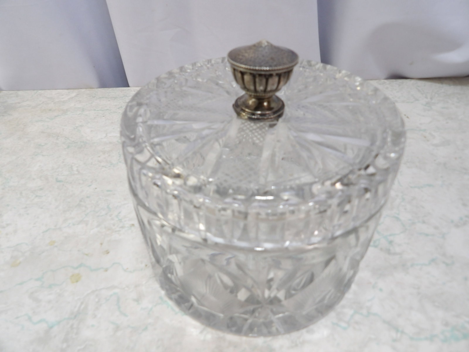 Cut Crystal Lidded Candy Bowl: Vintage Cut Crystal Lidded Candy Bowl with Hammered metal Handle. 5 1/2" Diameter. Along with LiveShip (handled by LiveAuctioneers), we also can have a local shipper package and ship your purchases.