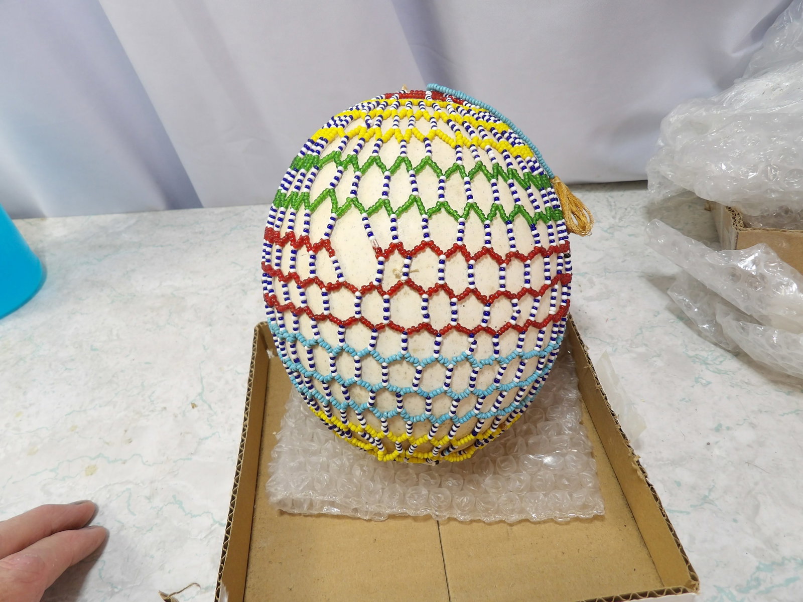 Vintage African Tribal Hand-Beaded Ostrich Egg: Vintage African Tribal Hand-Beaded Ostrich Egg. 7" tall. Along with LiveShip (handled by LiveAuctioneers), we also can have a local shipper package and ship your purchases. Just choose buyer arranges 