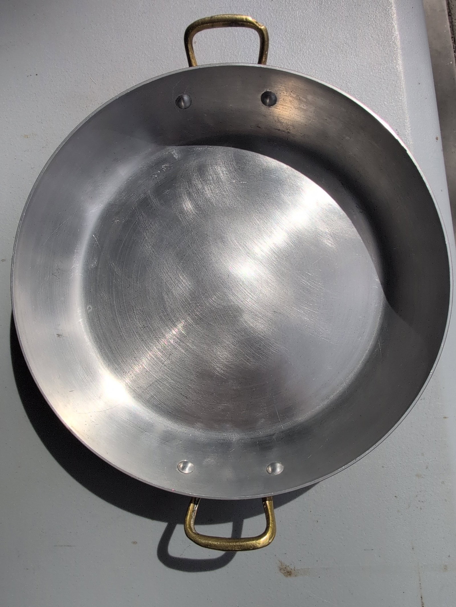 Mauviel France Copper Sauté Pan with Brass Handle: This is a vintage Mauviel France copper sauté pan, a high-quality piece from a renowned French cookware manufacturer. It features a thick copper exterior for excellent heat conductivity and a cast