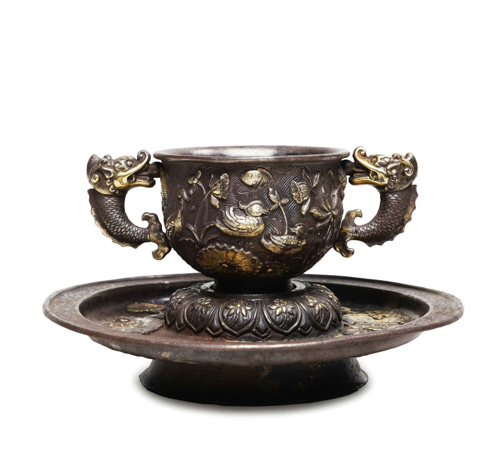 Qing Qianlong Period Silver Cup with Partial Gilding, Mandara Ears, Lotus Pond Mandarin Duck Pattern: H:8.8cmW:15.8cmWeight:338g This is a silver cup with partial gilding, mandara ears, lotus pond mandarin duck pattern and stand from the Qianlong period of the Qing Dynasty, a fine decorative silver