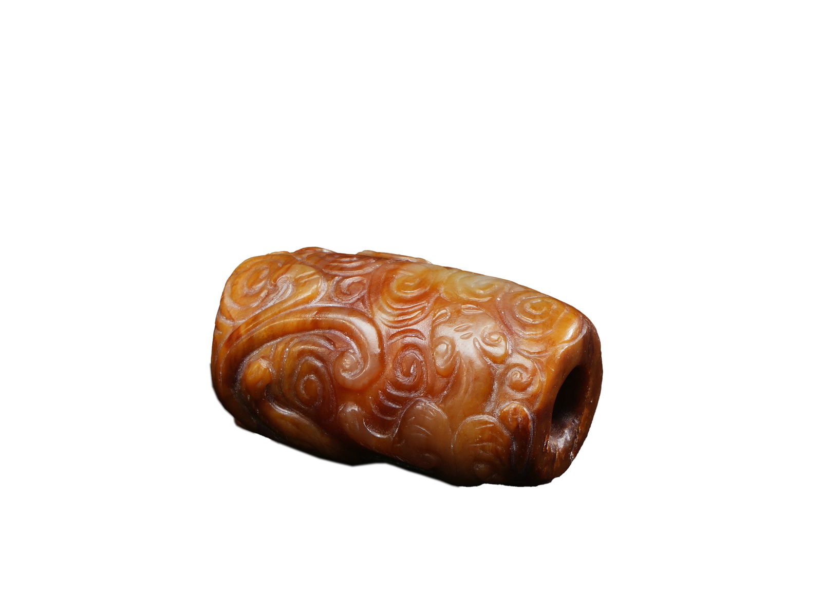 Ming Dynasty Yellow Jade Carved Bead with Cloud Motifs: L:3.2cmW:1.9cm This is a Ming Dynasty yellow jade carved bead with cloud motifs, featuring warm, compact, and golden-hued jade with natural brownish inclusions. The surface is fully carved with swirli