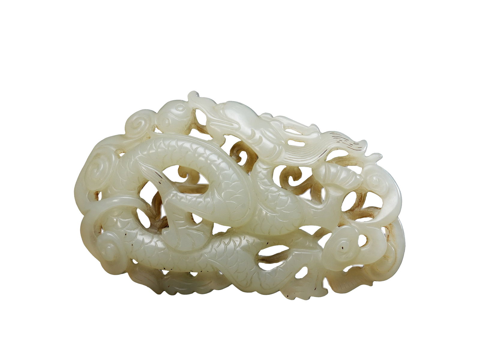 Ming Dynasty Hetian White Jade Openwork Cloud-Dragon Ornament: L:6.6cmW:4cm This is a Hetian white jade openwork cloud-dragon ornament from the Ming Dynasty, a fine court jade display piece of the Ming Dynasty. The ornament is made of Hetian white jade, with a wa