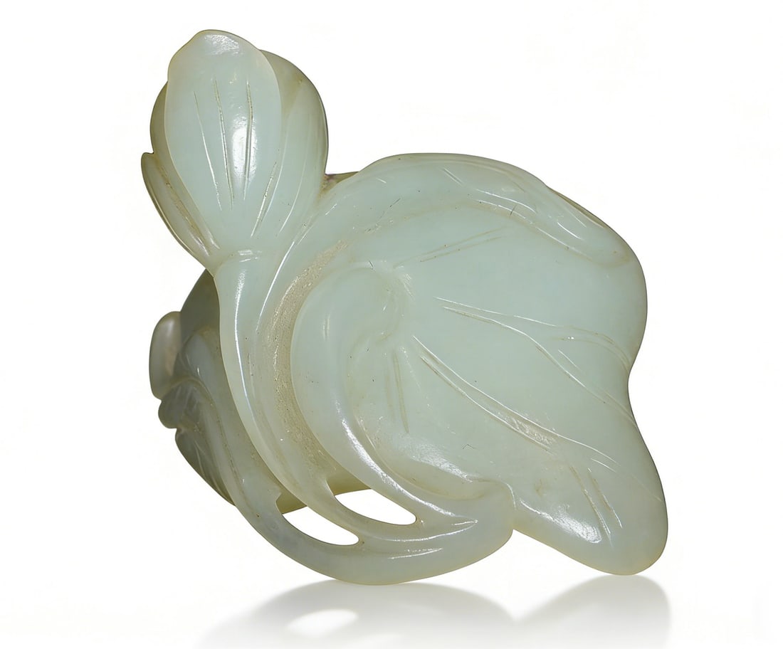 Qing Dynasty Hetian White Jade Carved Lotus-Hibiscus Handheld Ornament: H:3.5cmW:3.5cm This is a Qing Dynasty Hetian white jade carved lotus-hibiscus handheld ornament, a fine scholar’s object. Carved from Hetian white jade with warm, luminous, and fine texture; the for
