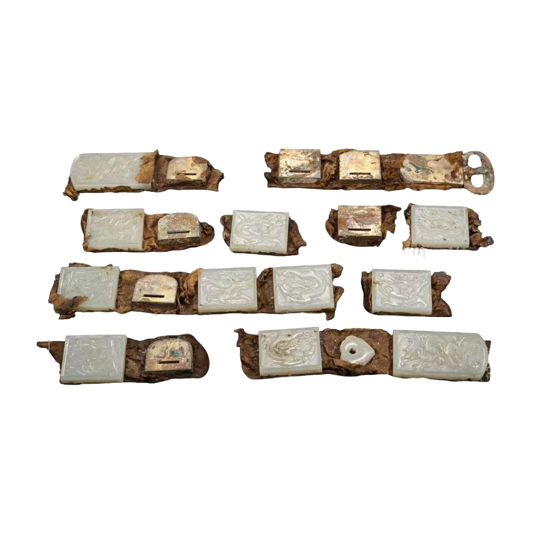 Liao Dynasty White Jade Belt Plates with Dragon Patterns: Size Vary Weight:1260g This is a set of nine Liao Dynasty white jade belt plates, paired with gilt metal fittings and a damaged leather belt. The plates are carved from high-quality white jade, which