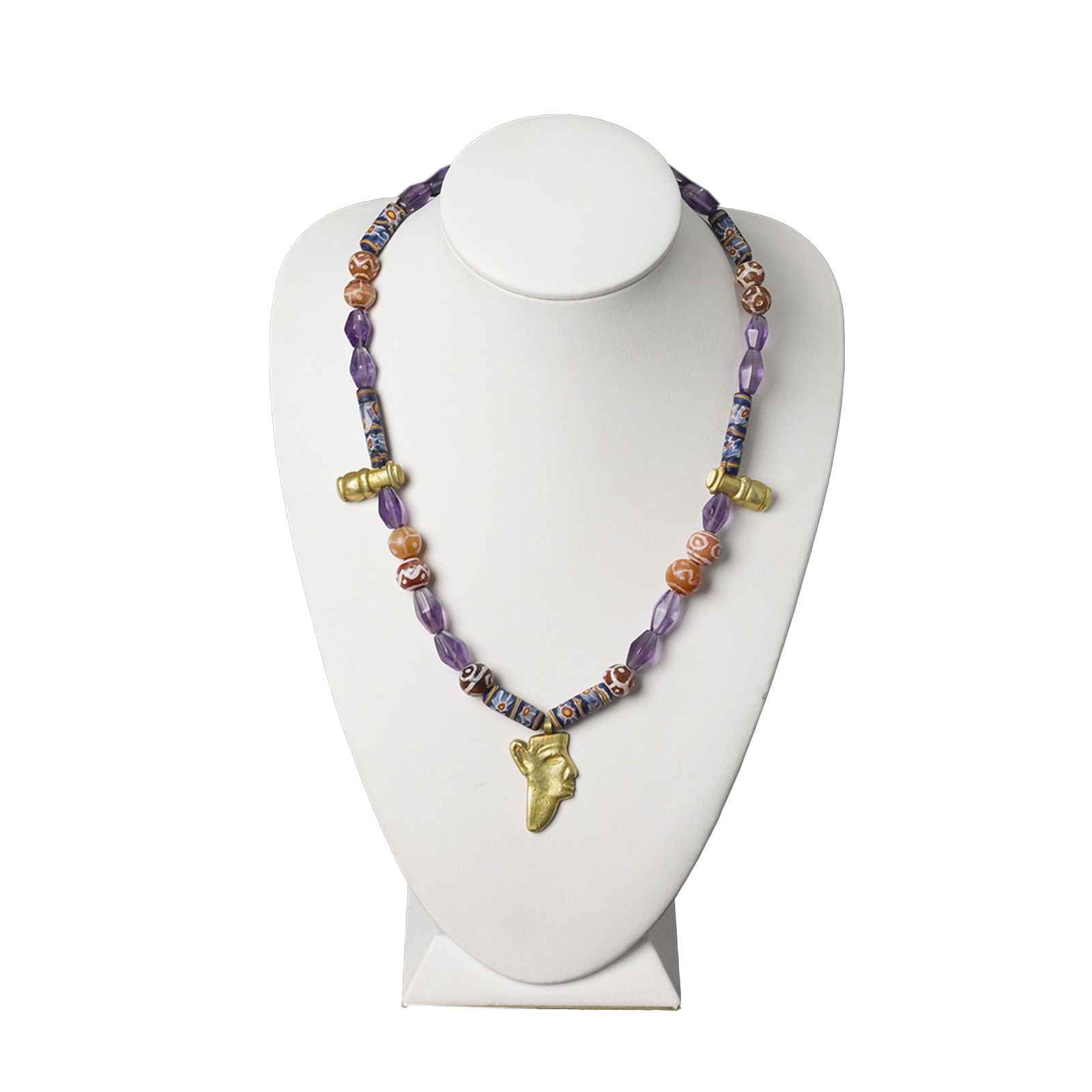 19K Gold Egyptian Face Pendant with Amethyst & Carnelian Pendants: Unique 19K gold pendant featuring an Egyptian face motif, accompanied by two additional gold pendants strung with amethyst glass showcasing eye patterns and etched carnelian stones. Total weight 56