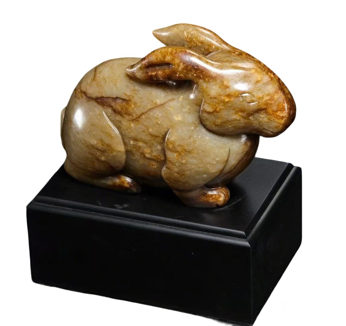 Ming Dynasty Jade Rabbit Ornament with Natural Patina: H:17cm W:15cm Weight:1506g This is a Ming Dynasty jade rabbit ornament with natural patina, carved from natural jade. The jade is warm and smooth with a natural brown patina, showcasing a (ancient) co