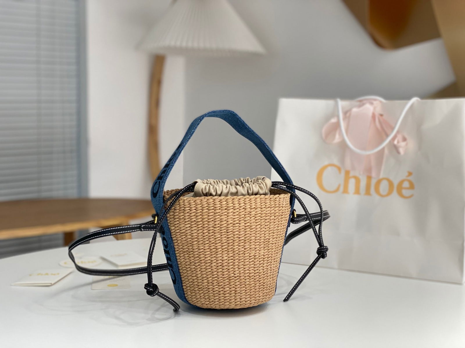 Chloe Woody: The Chloe Woody denim woven straw bucket bag is a highly popular choice among women, combining practicality, versatility, and a stylish look. This Chloe Woody straw bucket bag features a cute, hand wo