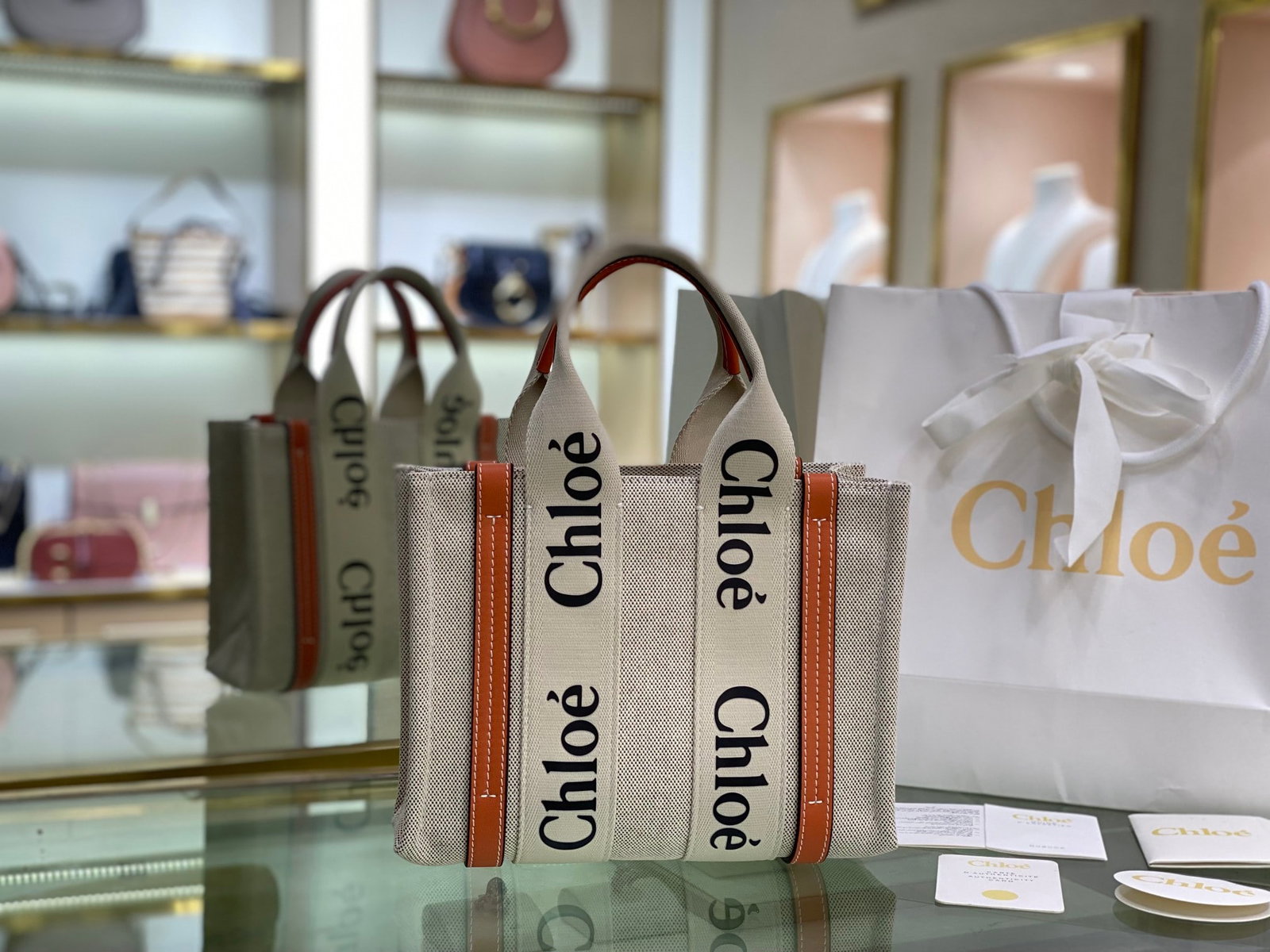 Chloe Woody Tote: The orange, strapless Chloe Woody Tote canvas tote bag has been a hit with many women since its release. The bag is crafted from tightly woven waterproof cotton canvas. The black and white Chloe logo